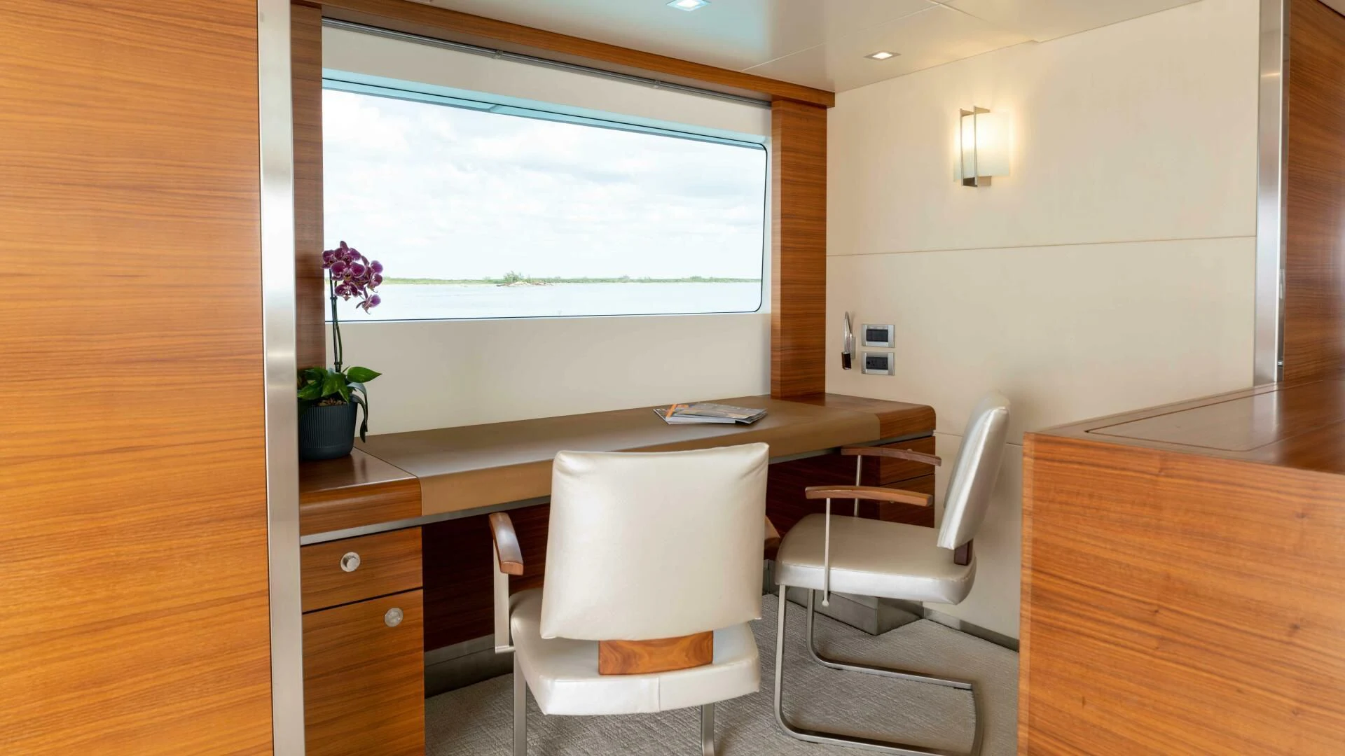 a room with a desk and chairs aboard SEA AXIS Yacht for Charter