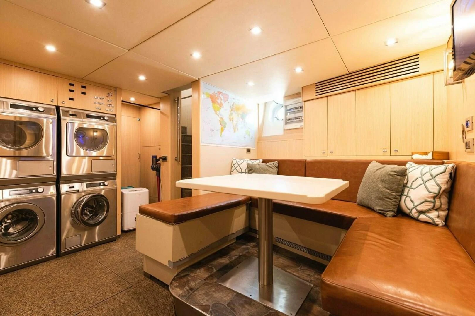 a kitchen with a table and a couch aboard SEA AXIS Yacht for Charter