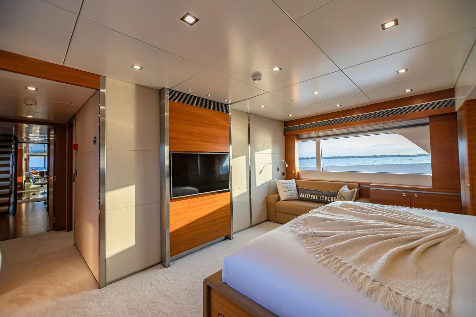 a bedroom with a large window aboard SEA AXIS Yacht for Charter