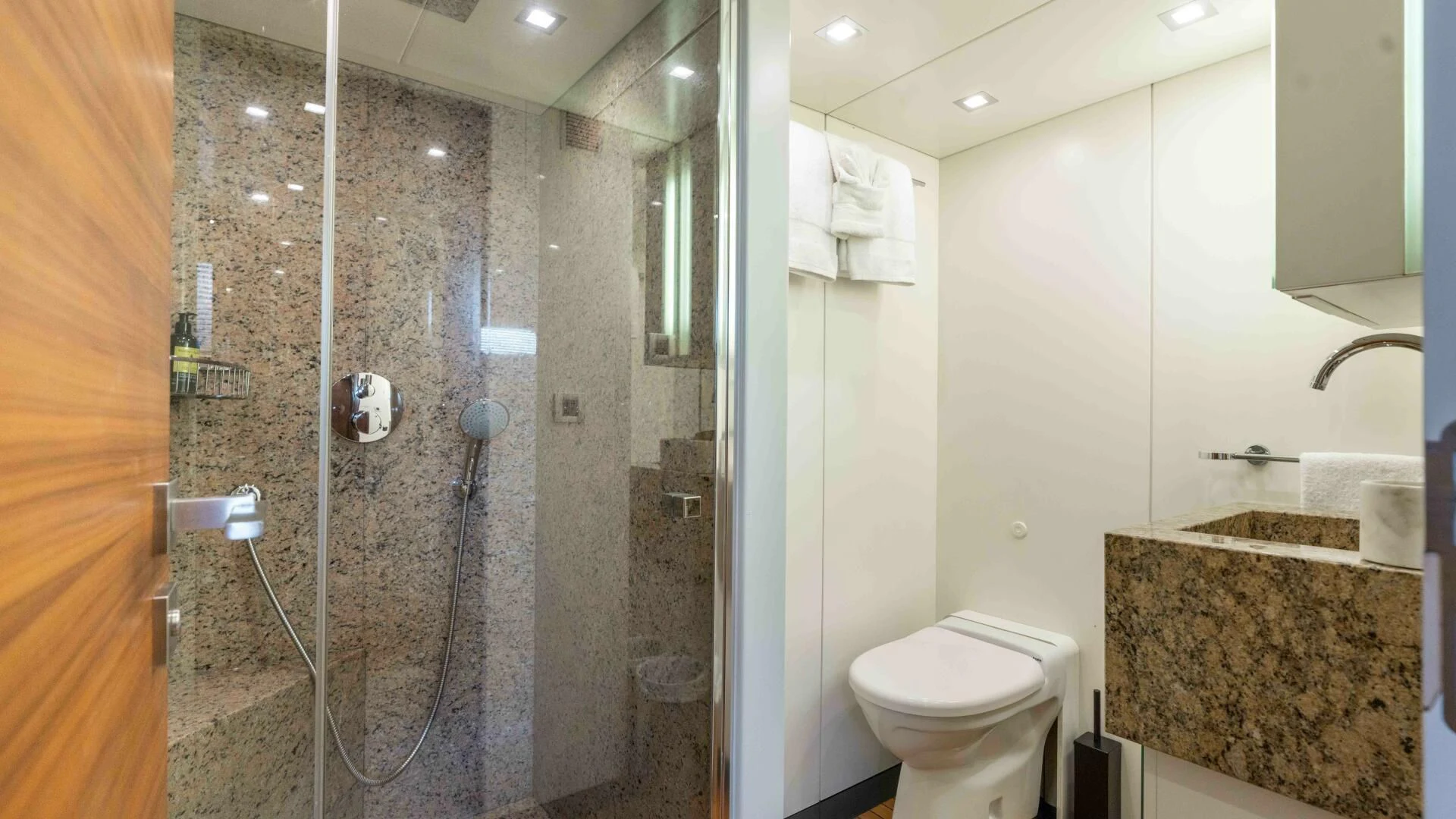 a bathroom with a shower and toilet aboard SEA AXIS Yacht for Charter