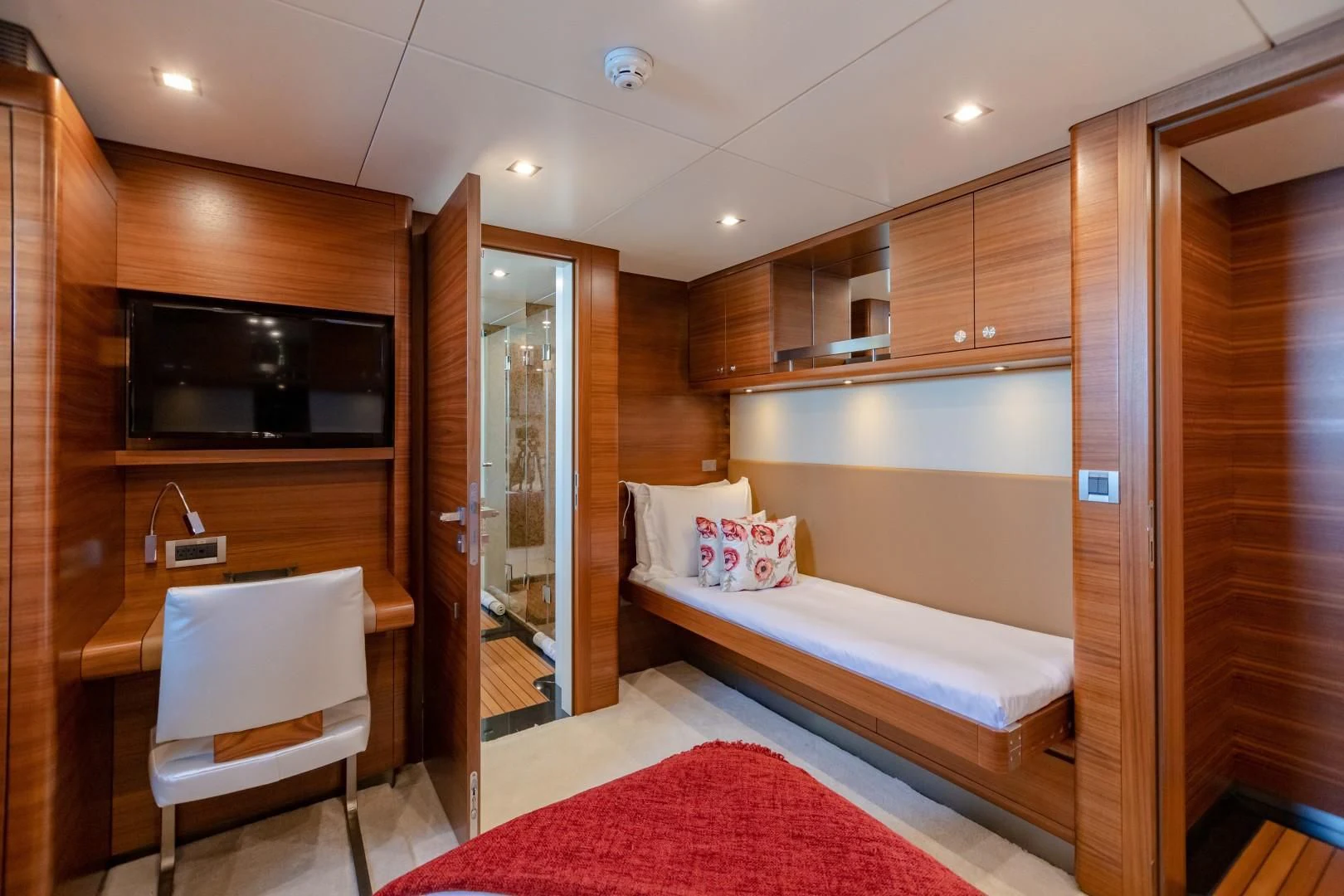 a room with a bed and a television aboard SEA AXIS Yacht for Charter