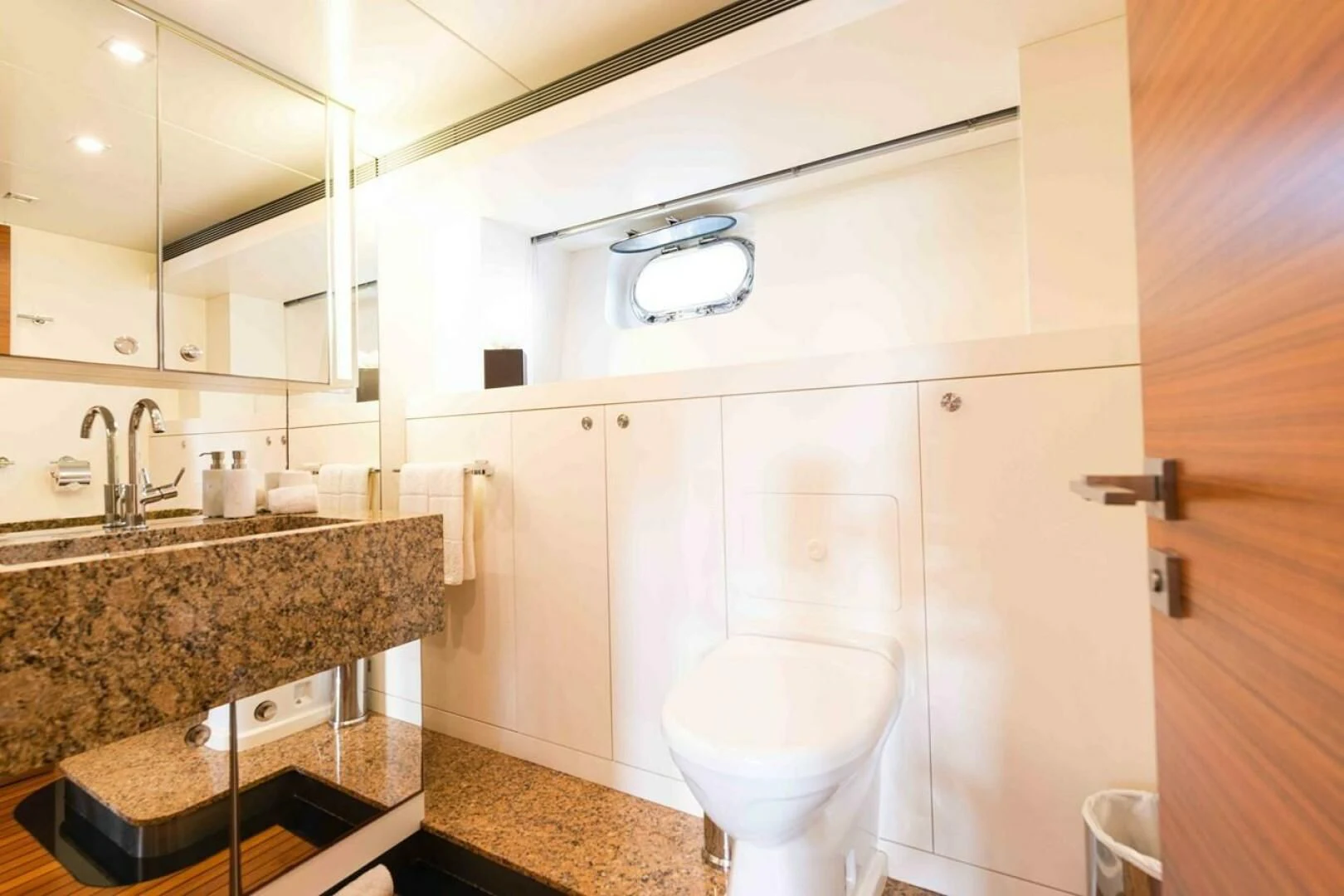a bathroom with a toilet and sink aboard SEA AXIS Yacht for Charter