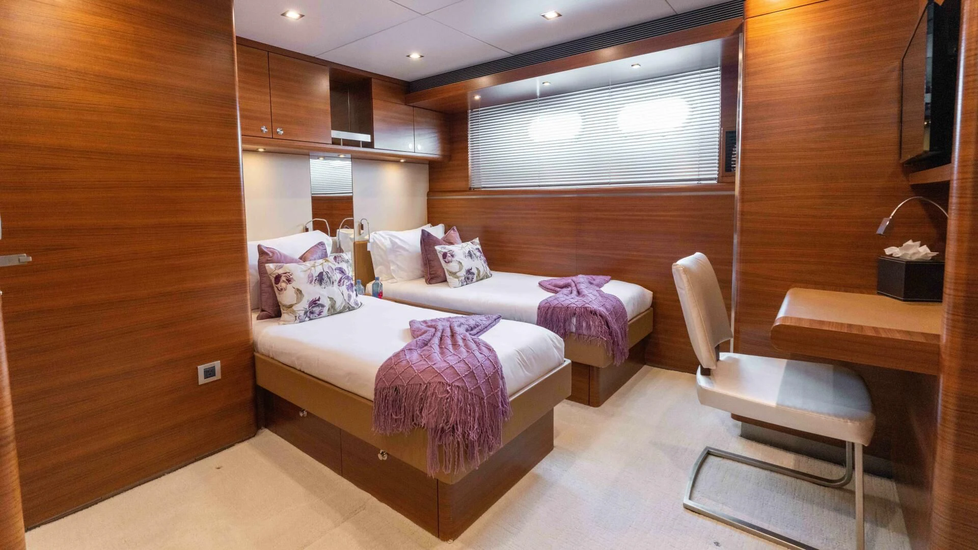a room with a bed and a chair aboard SEA AXIS Yacht for Charter