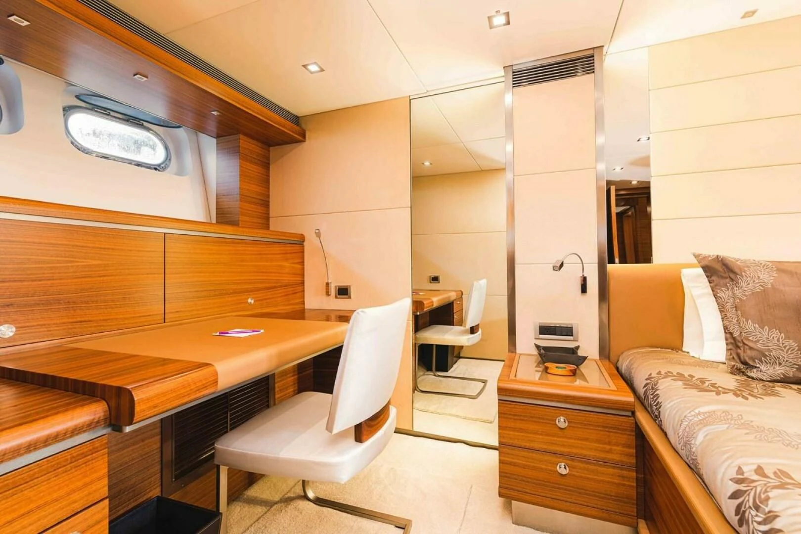 a room with a bed and desk aboard SEA AXIS Yacht for Charter