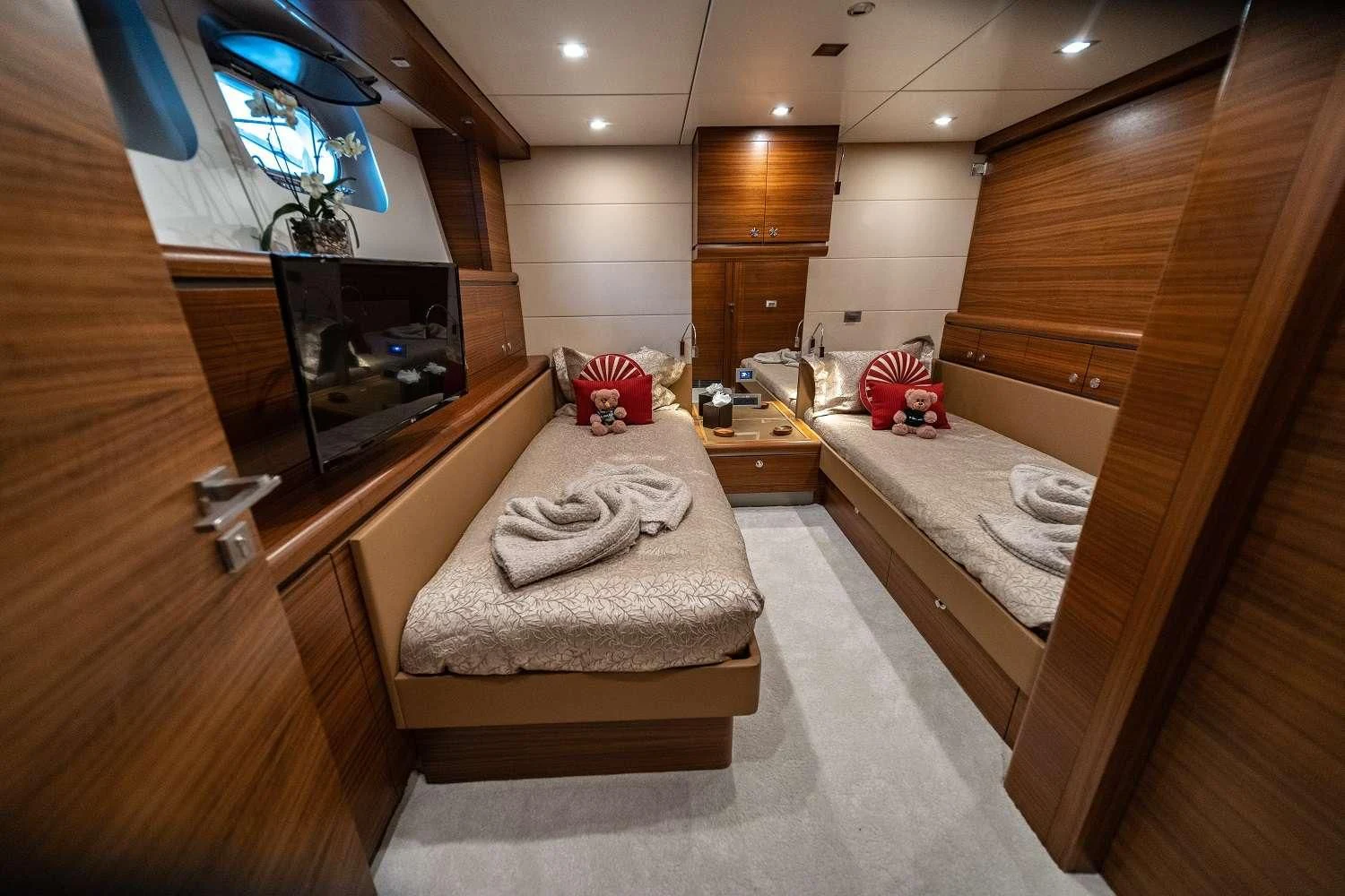 a room with a bed and tv aboard SEA AXIS Yacht for Charter