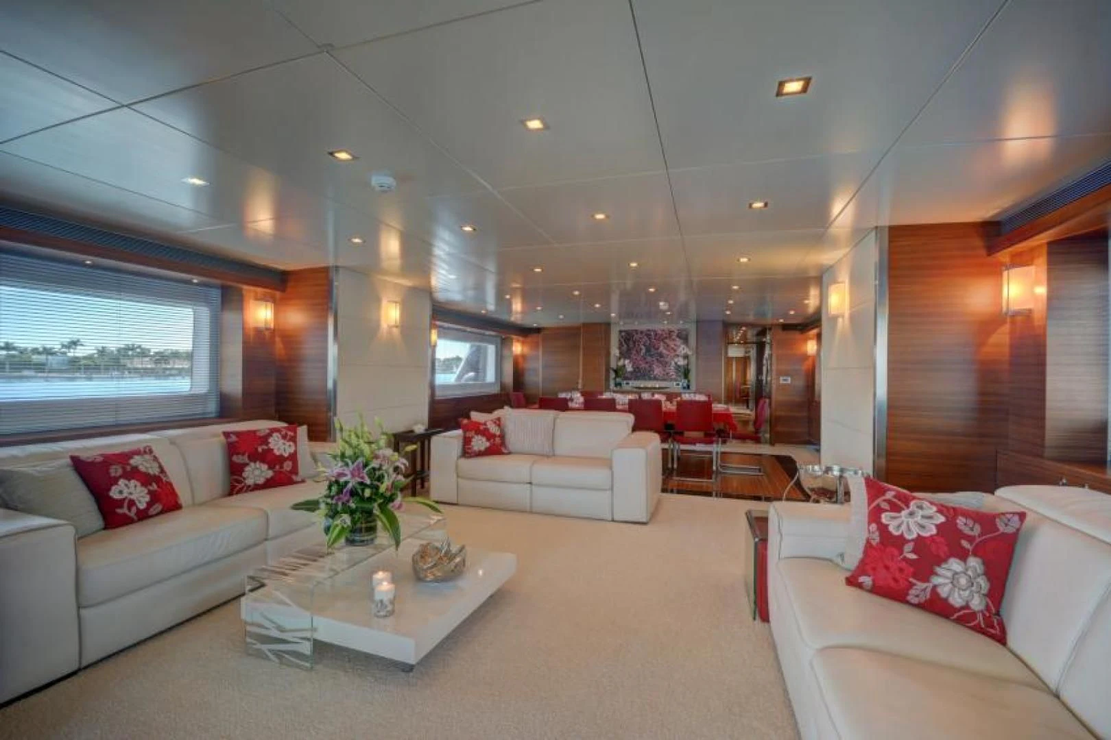 a living room with white couches and a large window aboard SEA AXIS Yacht for Charter