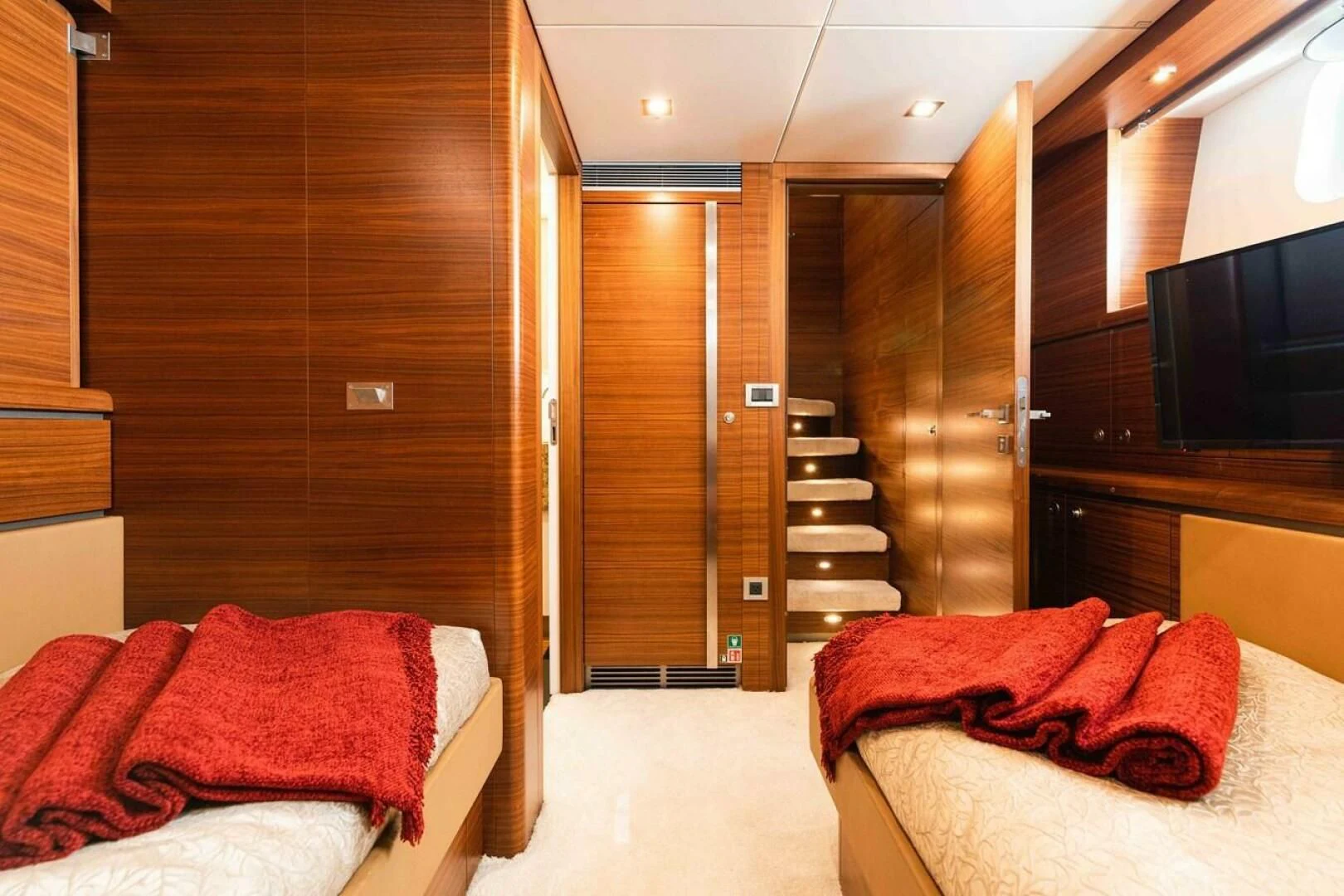 a room with a bed and a tv aboard SEA AXIS Yacht for Charter