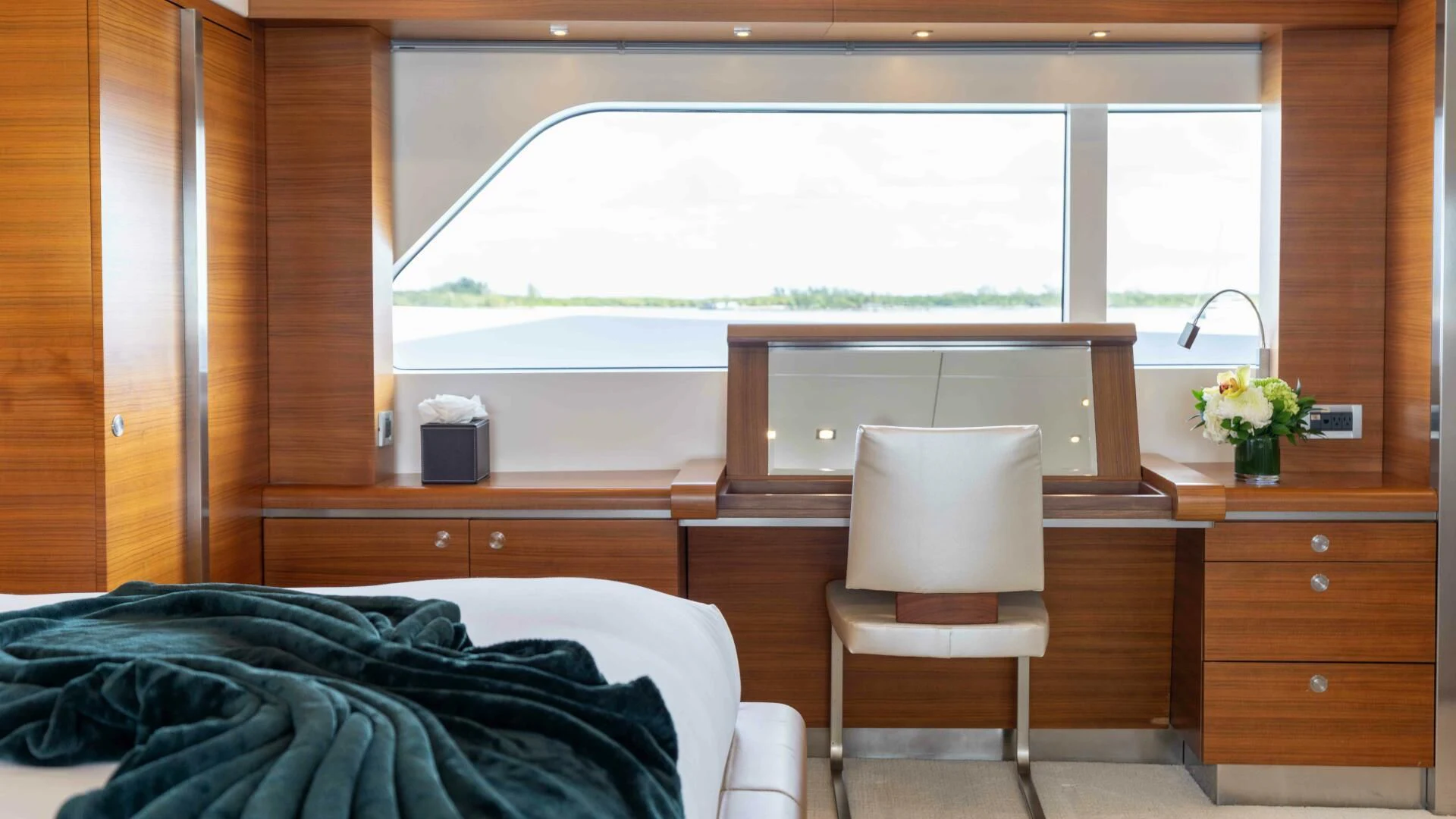 a room with a bed and a chair aboard SEA AXIS Yacht for Charter