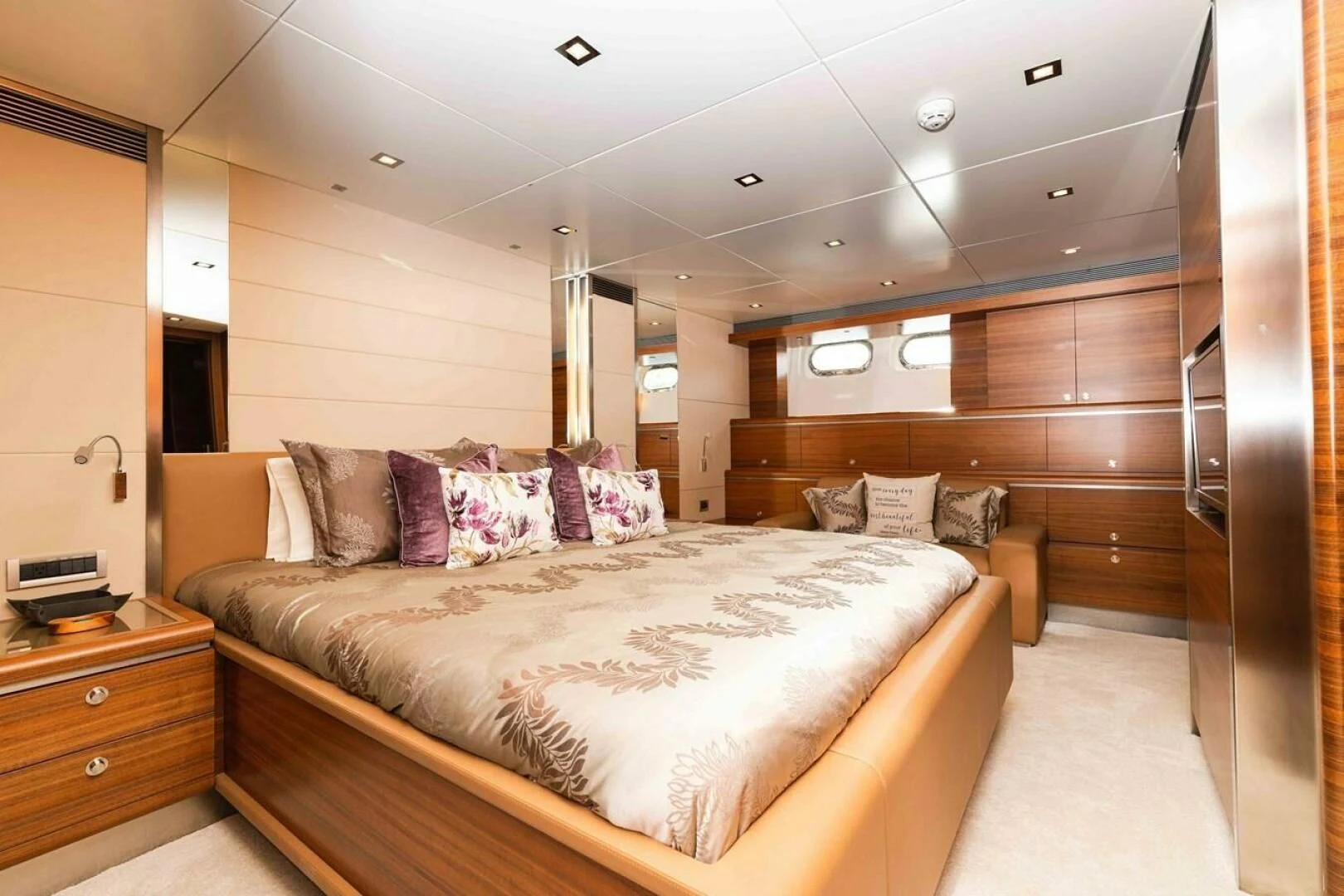 a bedroom with a bed and a wood wall aboard SEA AXIS Yacht for Charter