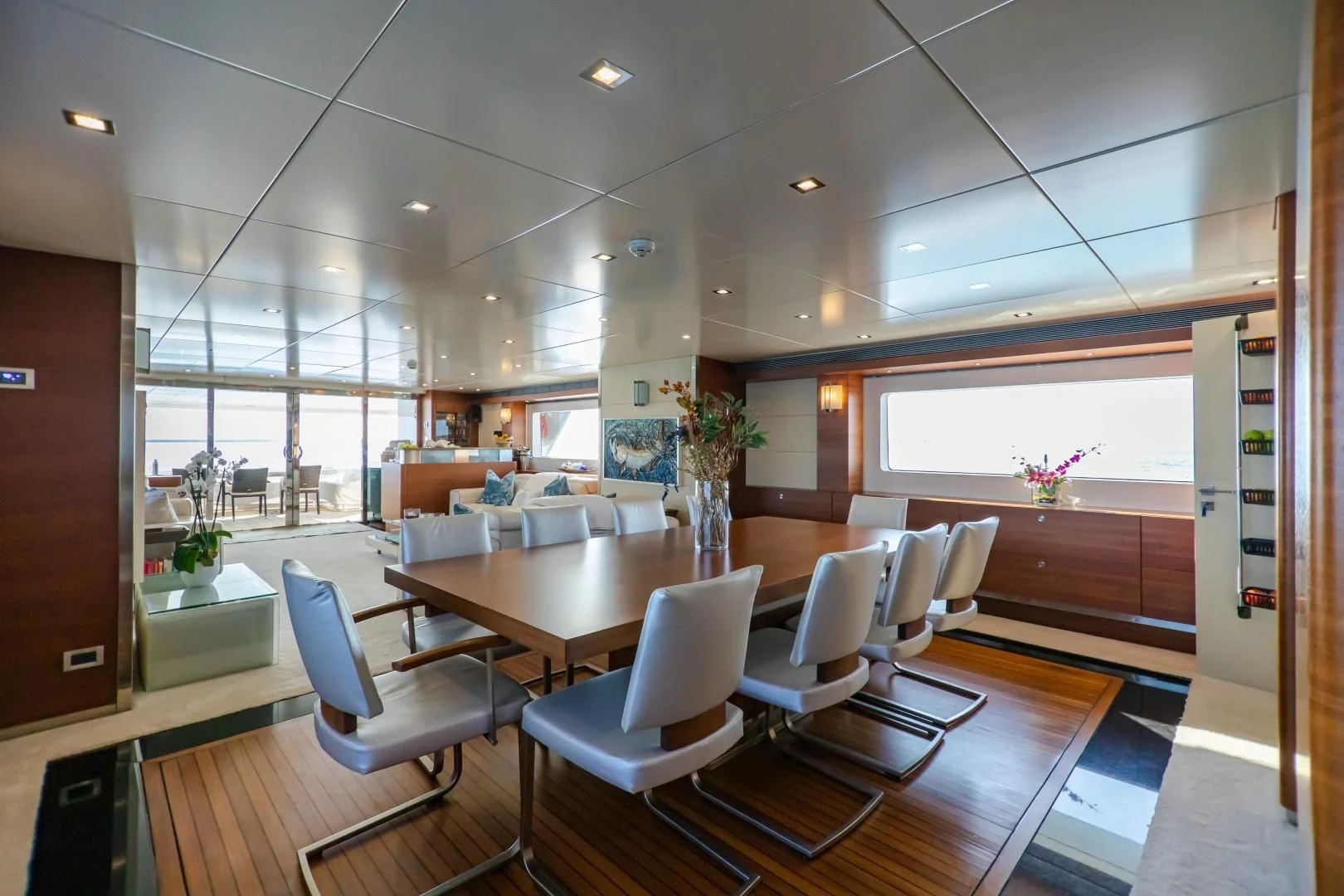 a room with a table chairs and a window aboard SEA AXIS Yacht for Charter