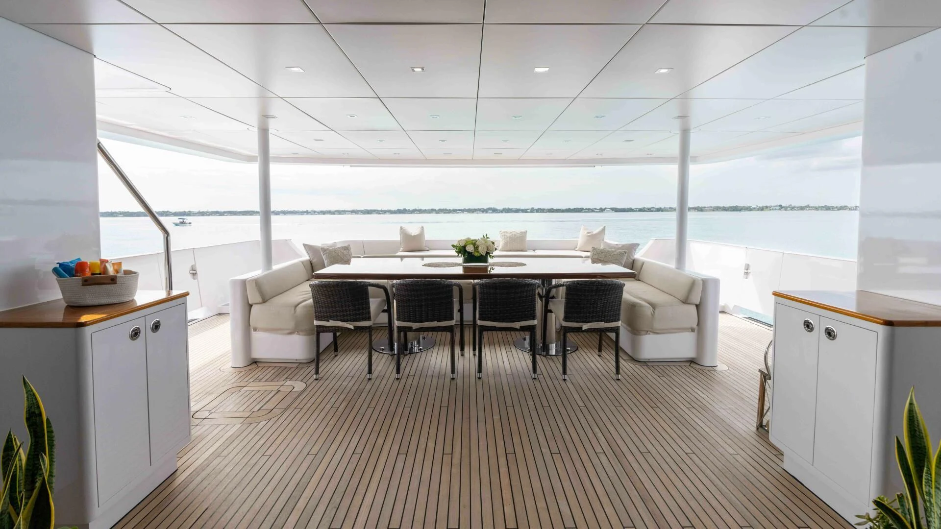 a room with a table chairs and a large window aboard SEA AXIS Yacht for Charter