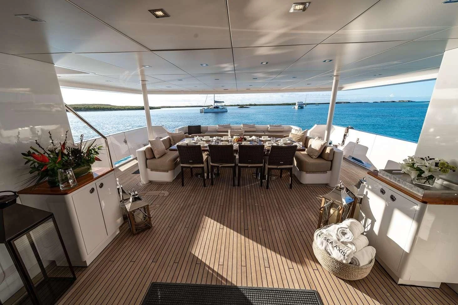 a room with a table chairs and a plant on the wall aboard SEA AXIS Yacht for Charter