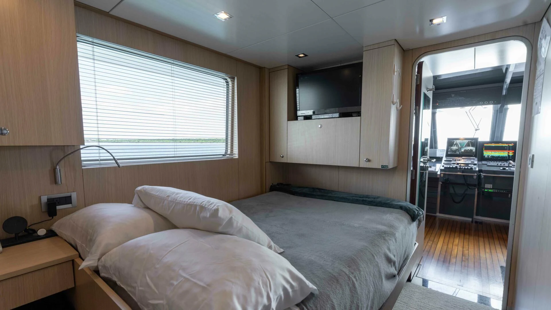a bedroom with a bed and a desk aboard SEA AXIS Yacht for Charter