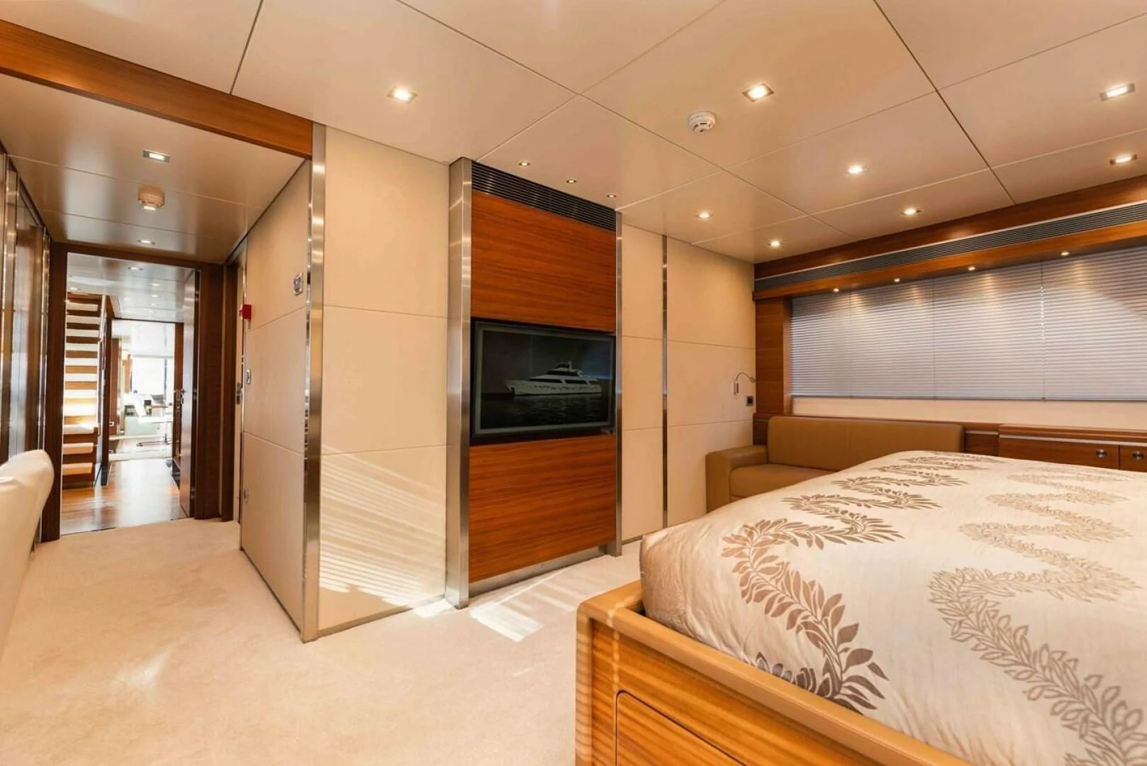 a room with a bed and a tv aboard SEA AXIS Yacht for Charter
