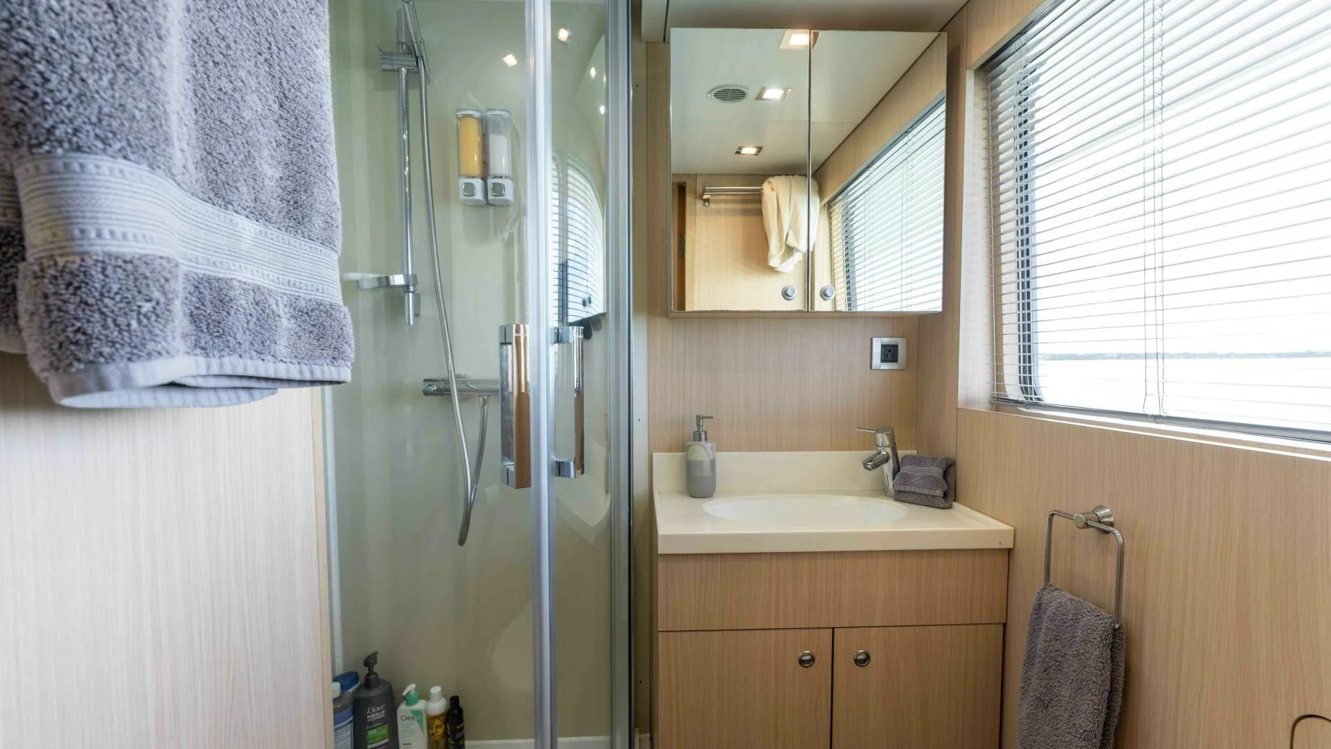 a bathroom with a shower unit and sink aboard SEA AXIS Yacht for Charter