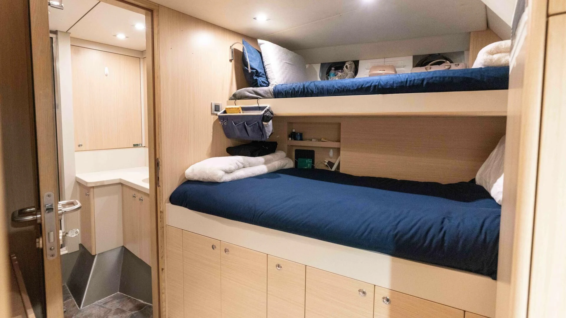 a room with a bed and a closet aboard SEA AXIS Yacht for Charter