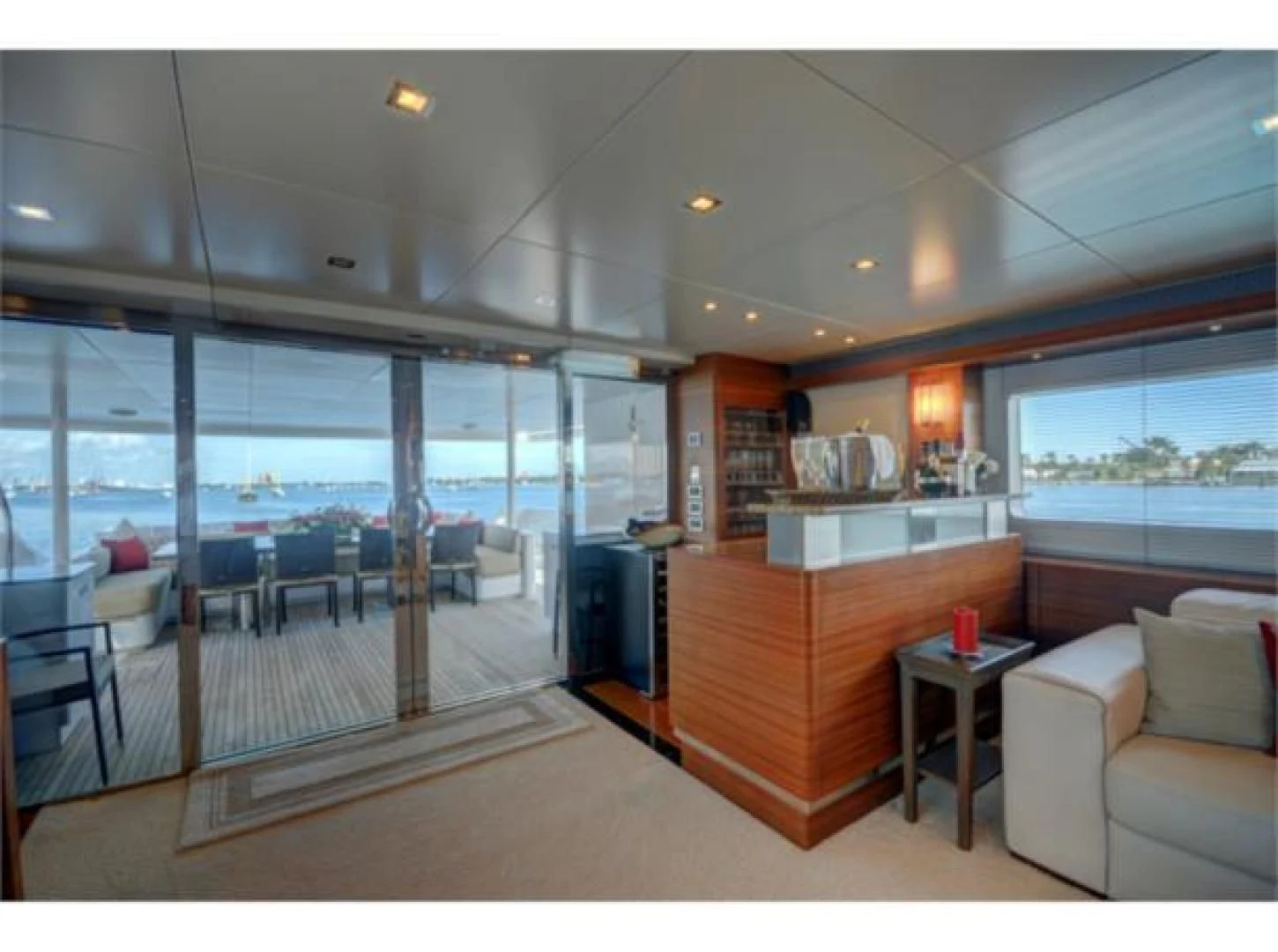a room with a large window and a table and chairs aboard SEA AXIS Yacht for Charter
