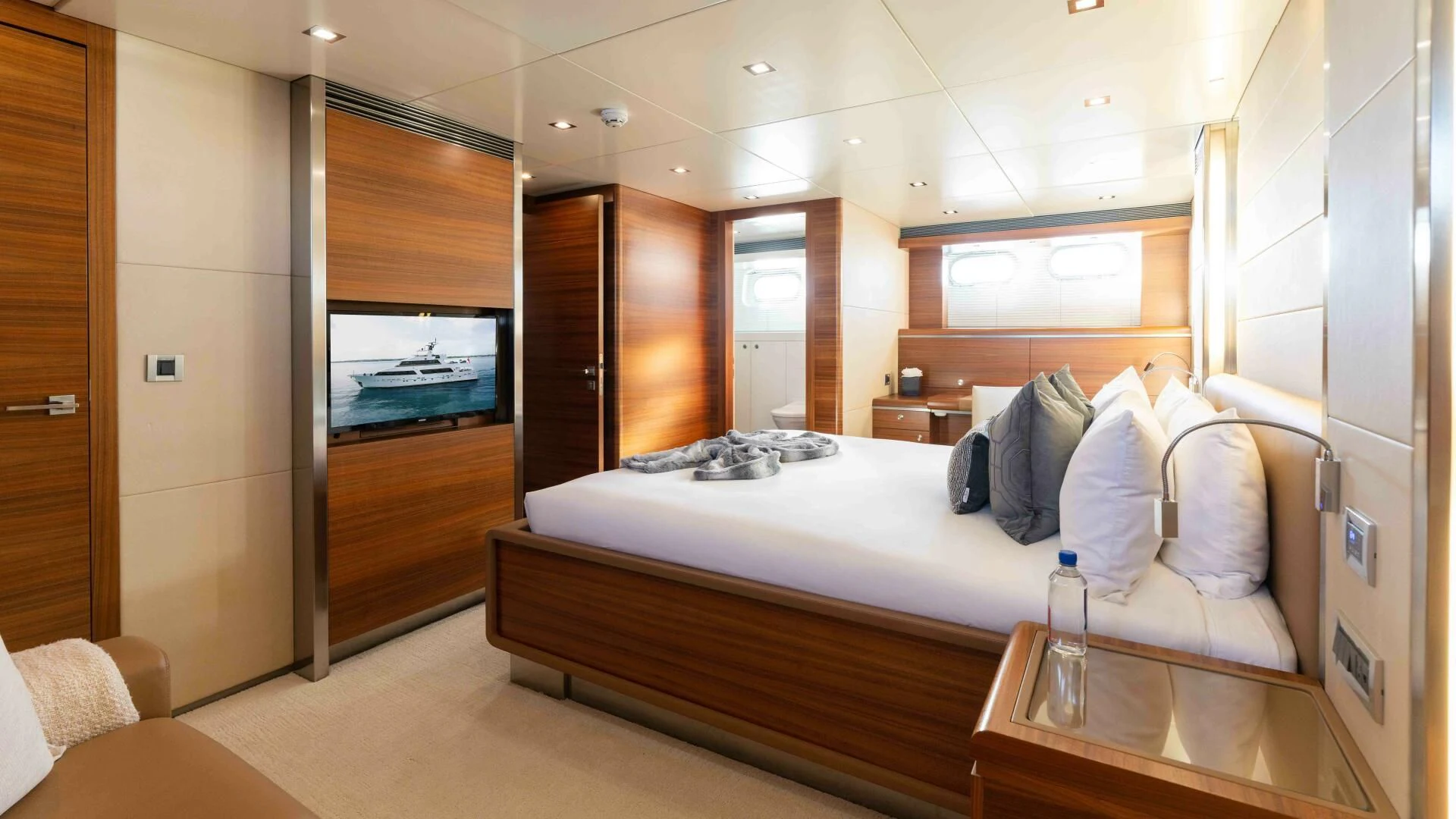 a room with a bed and a table aboard SEA AXIS Yacht for Charter