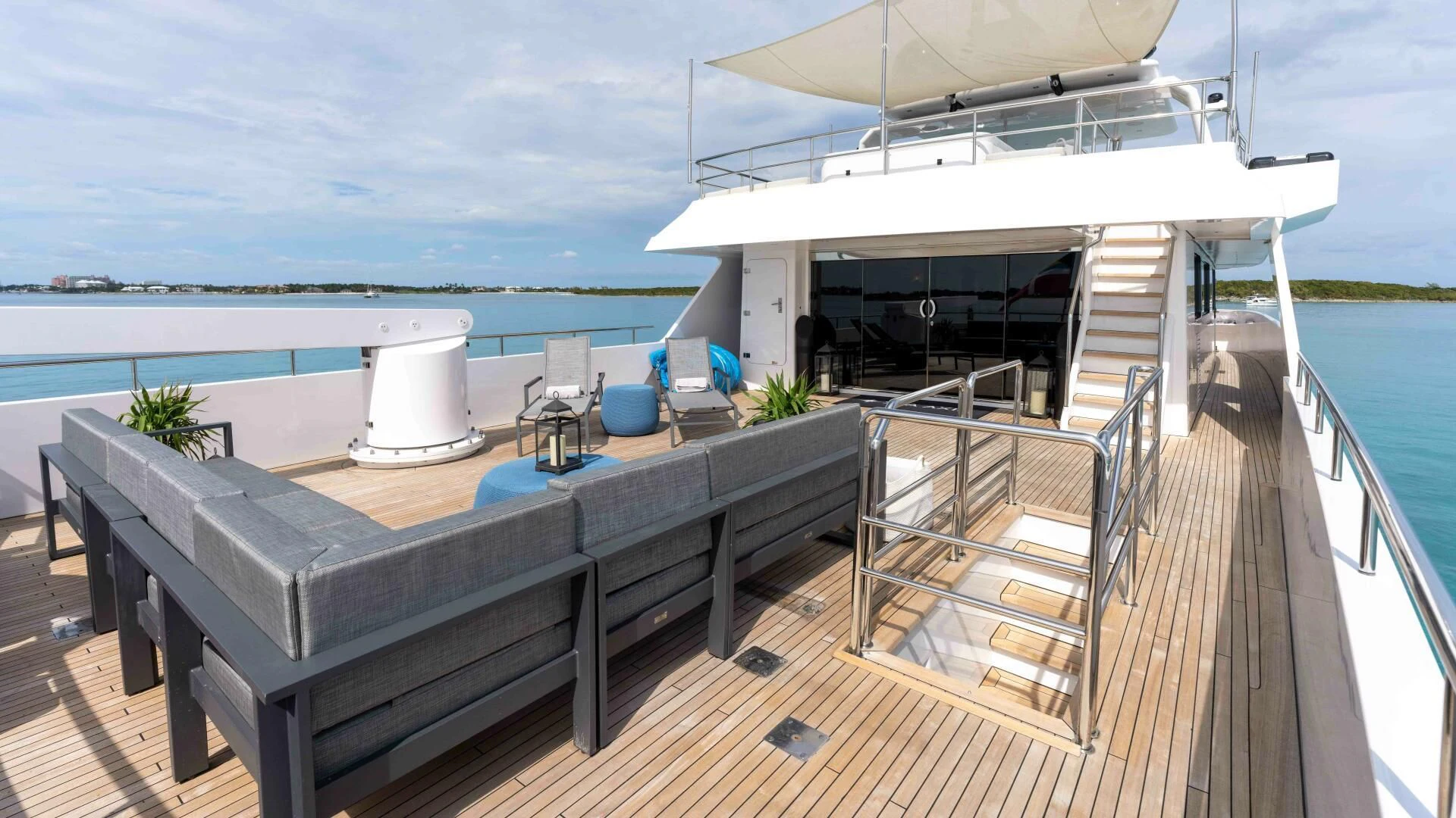 a deck with a large white boat on it aboard SEA AXIS Yacht for Charter