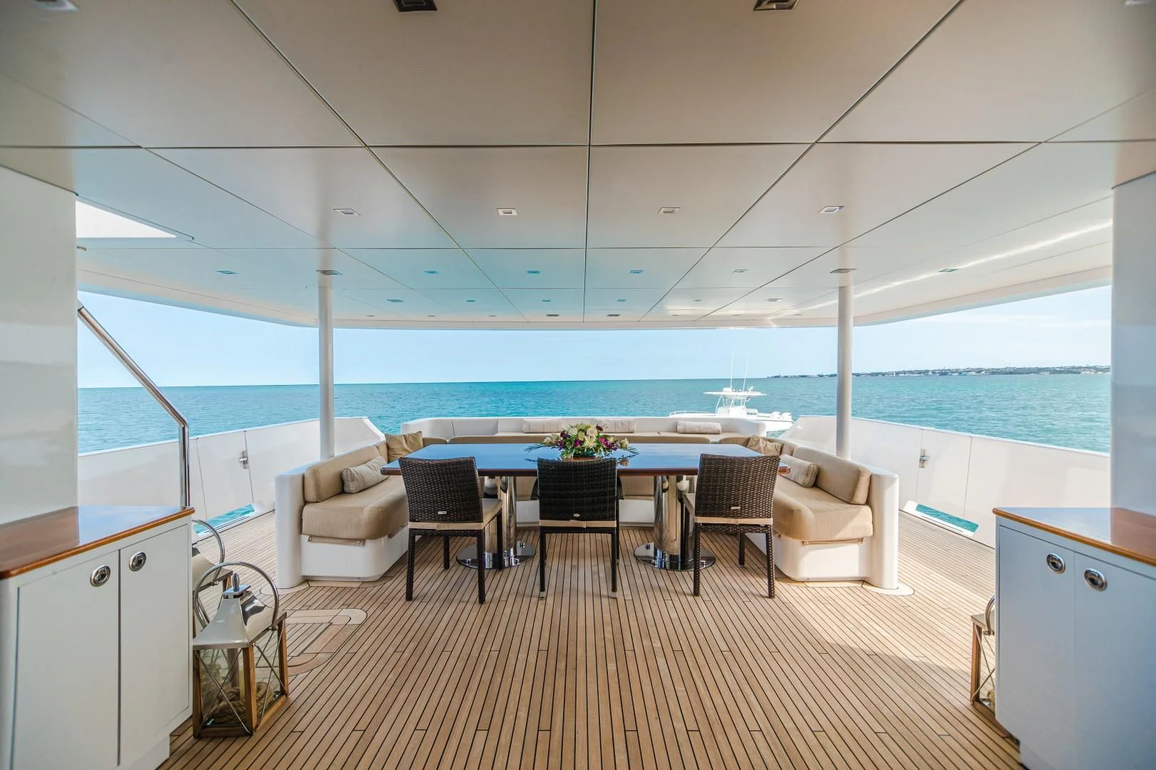 a room with a table chairs and a large pool aboard SEA AXIS Yacht for Charter