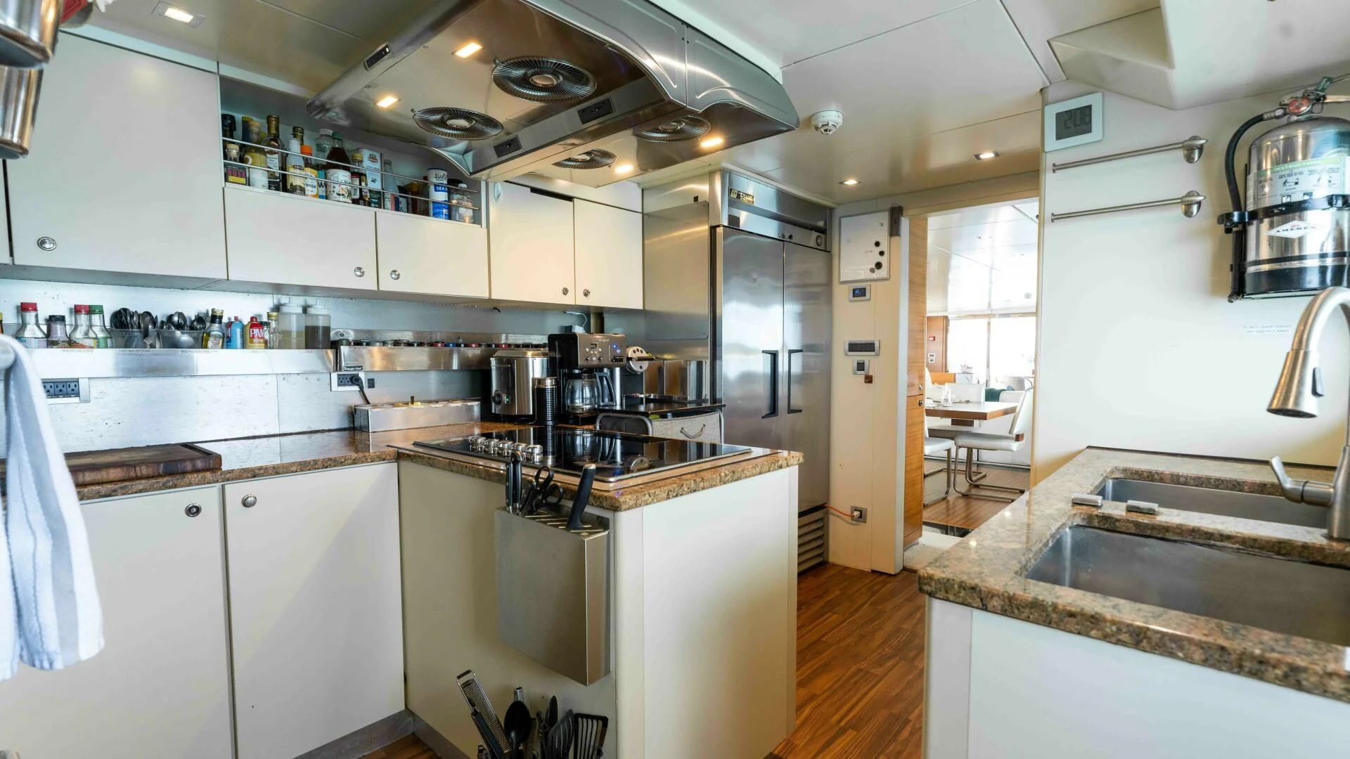 a kitchen with white cabinets aboard SEA AXIS Yacht for Charter