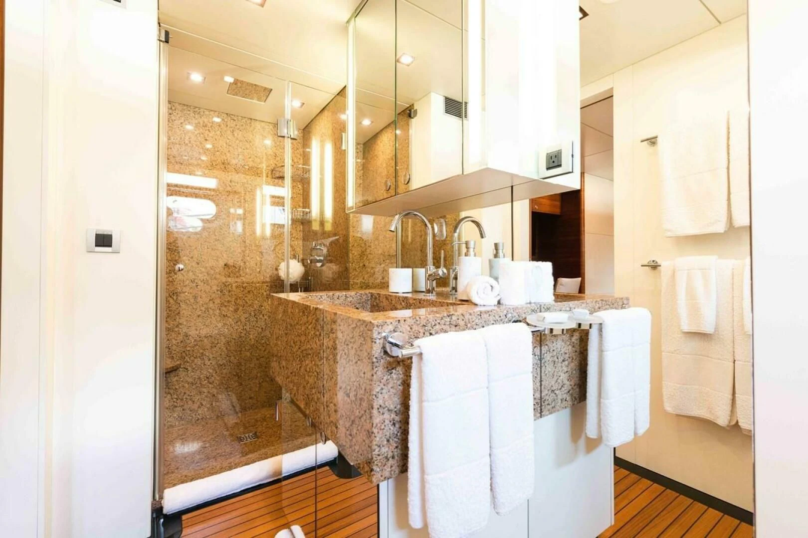 a bathroom with a sink and a shower aboard SEA AXIS Yacht for Charter