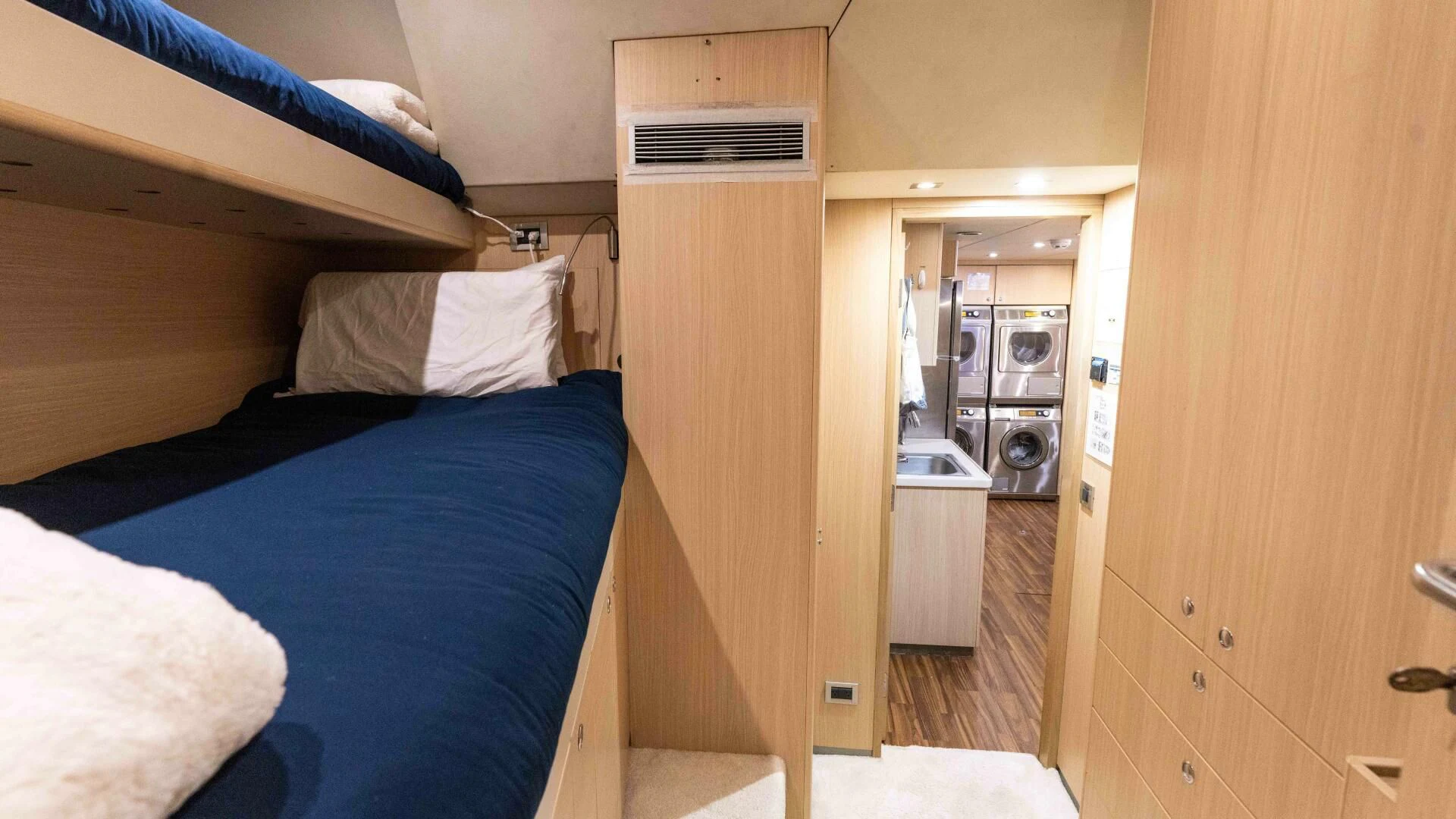 a room with a bed and a closet aboard SEA AXIS Yacht for Charter