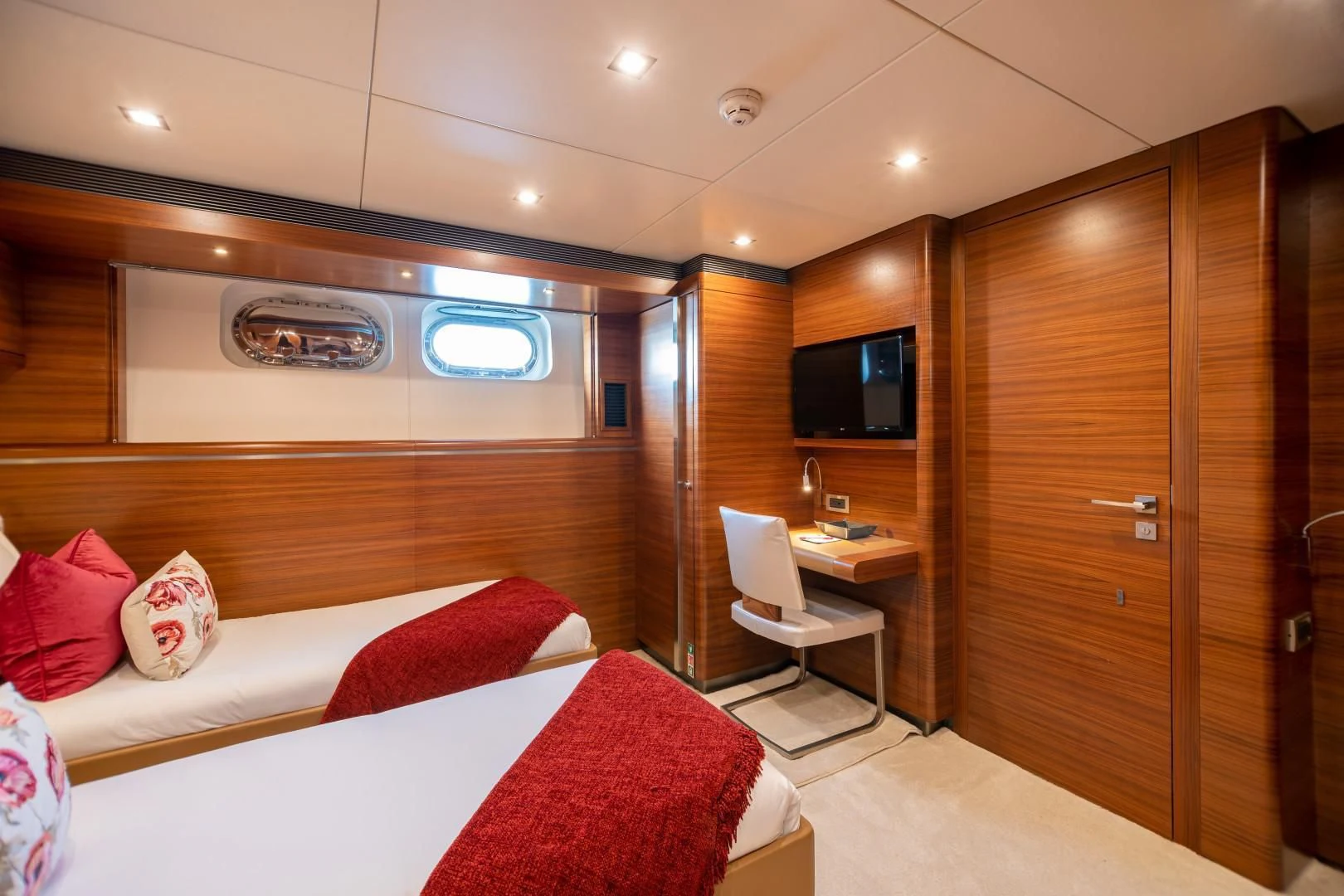 a room with a bed and a desk aboard SEA AXIS Yacht for Charter