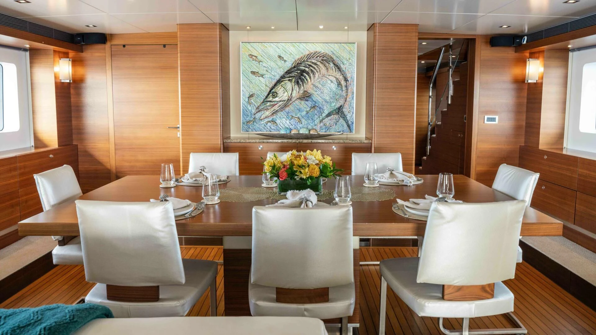 a table with chairs and a large painting on it aboard SEA AXIS Yacht for Charter