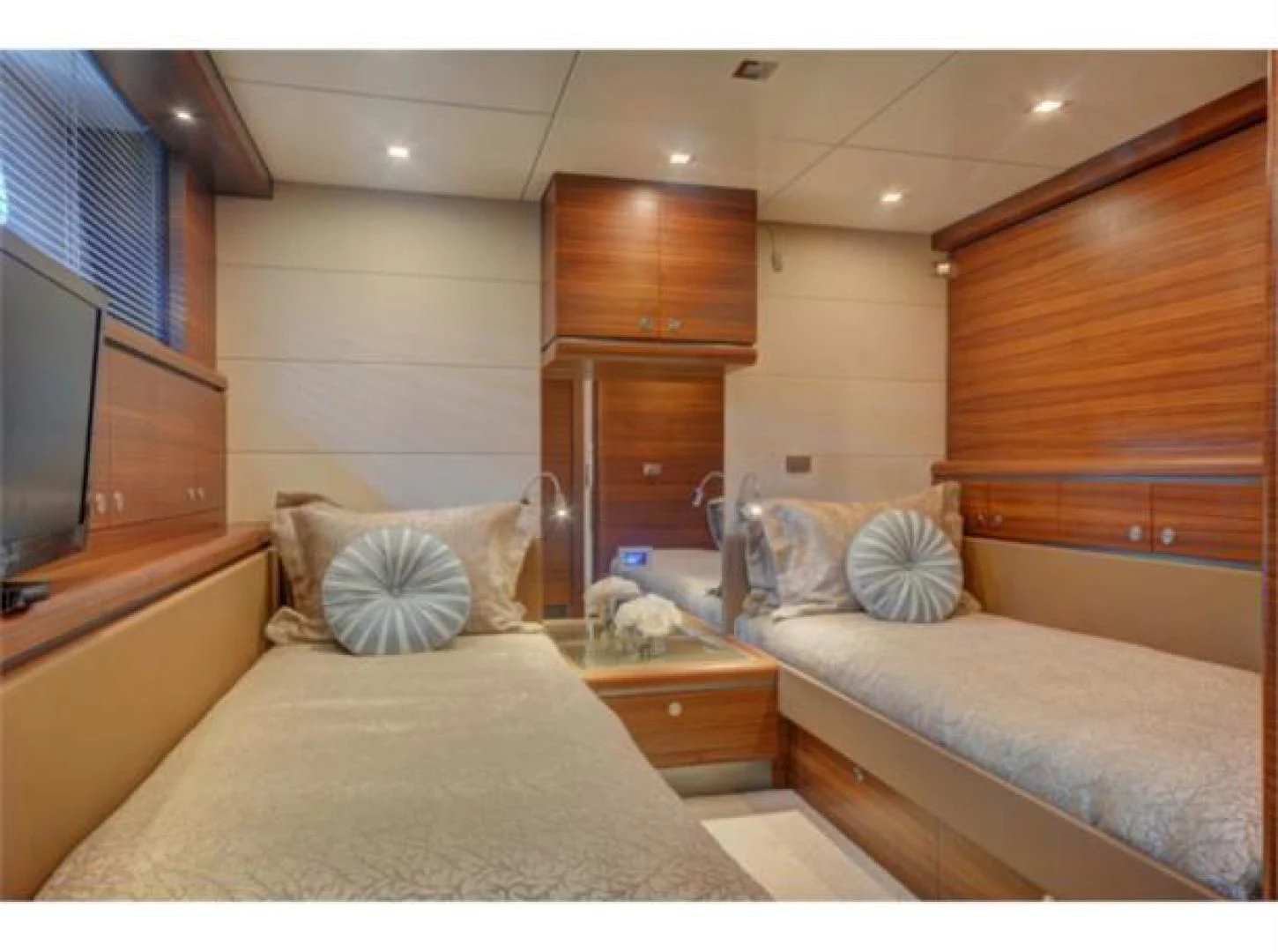a room with a bed and a television aboard SEA AXIS Yacht for Charter
