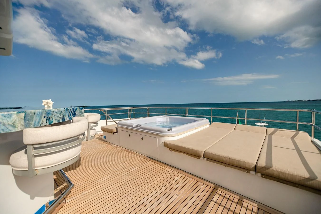 a pool with a chair and a table on a deck aboard SEA AXIS Yacht for Charter