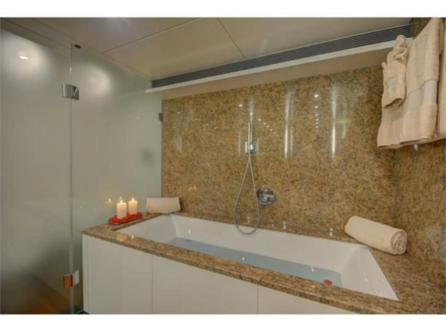 a bathroom with a bathtub and a shower aboard SEA AXIS Yacht for Charter