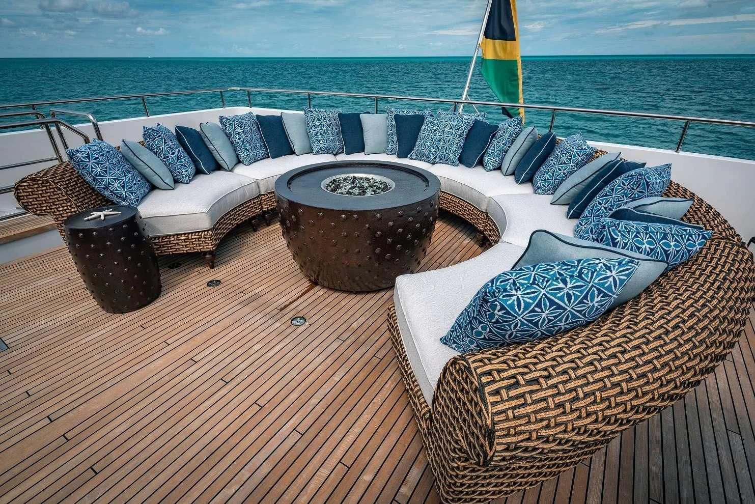 a deck with a couch and a table on it aboard SEA AXIS Yacht for Charter