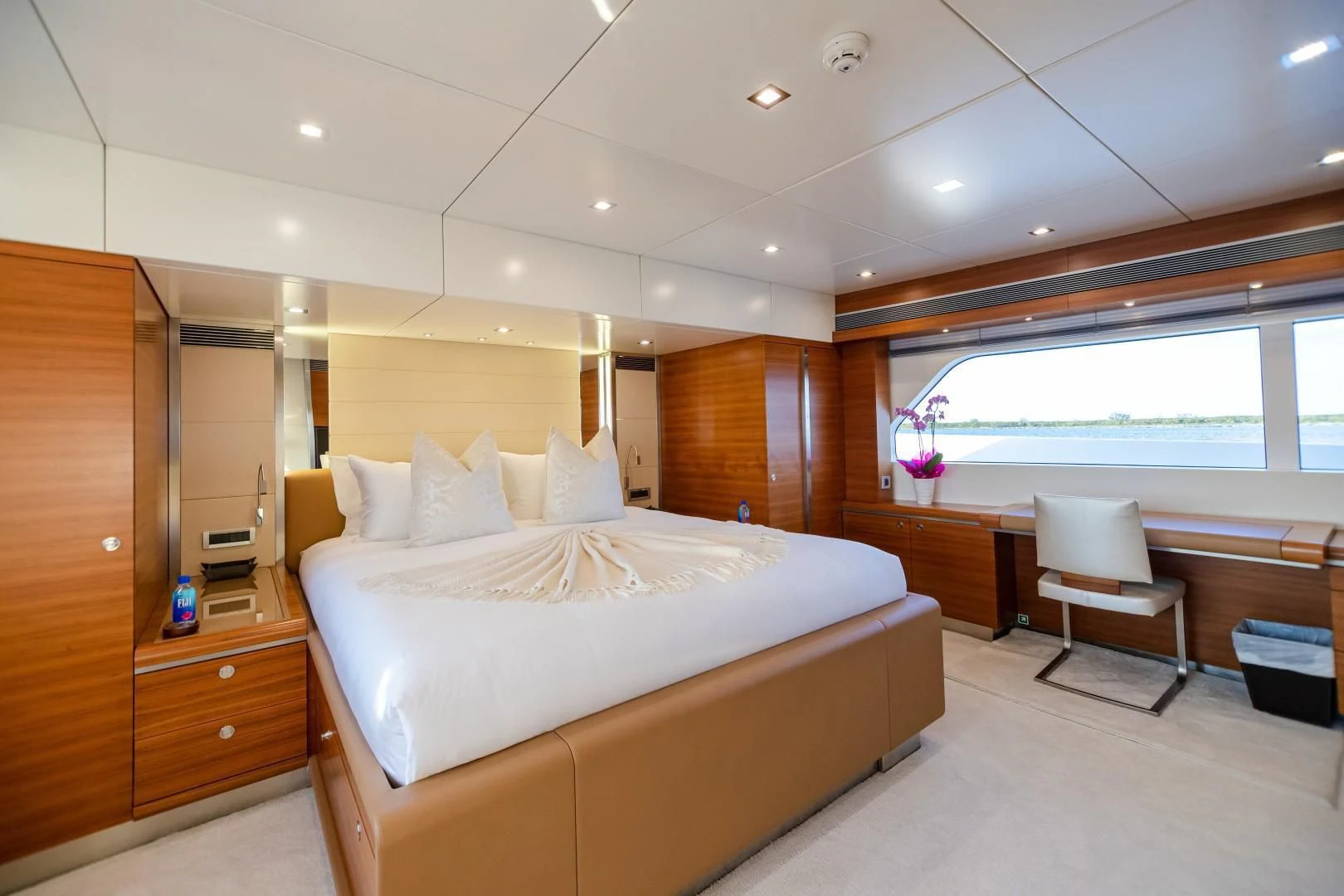 a room with a bed and a chair aboard SEA AXIS Yacht for Charter