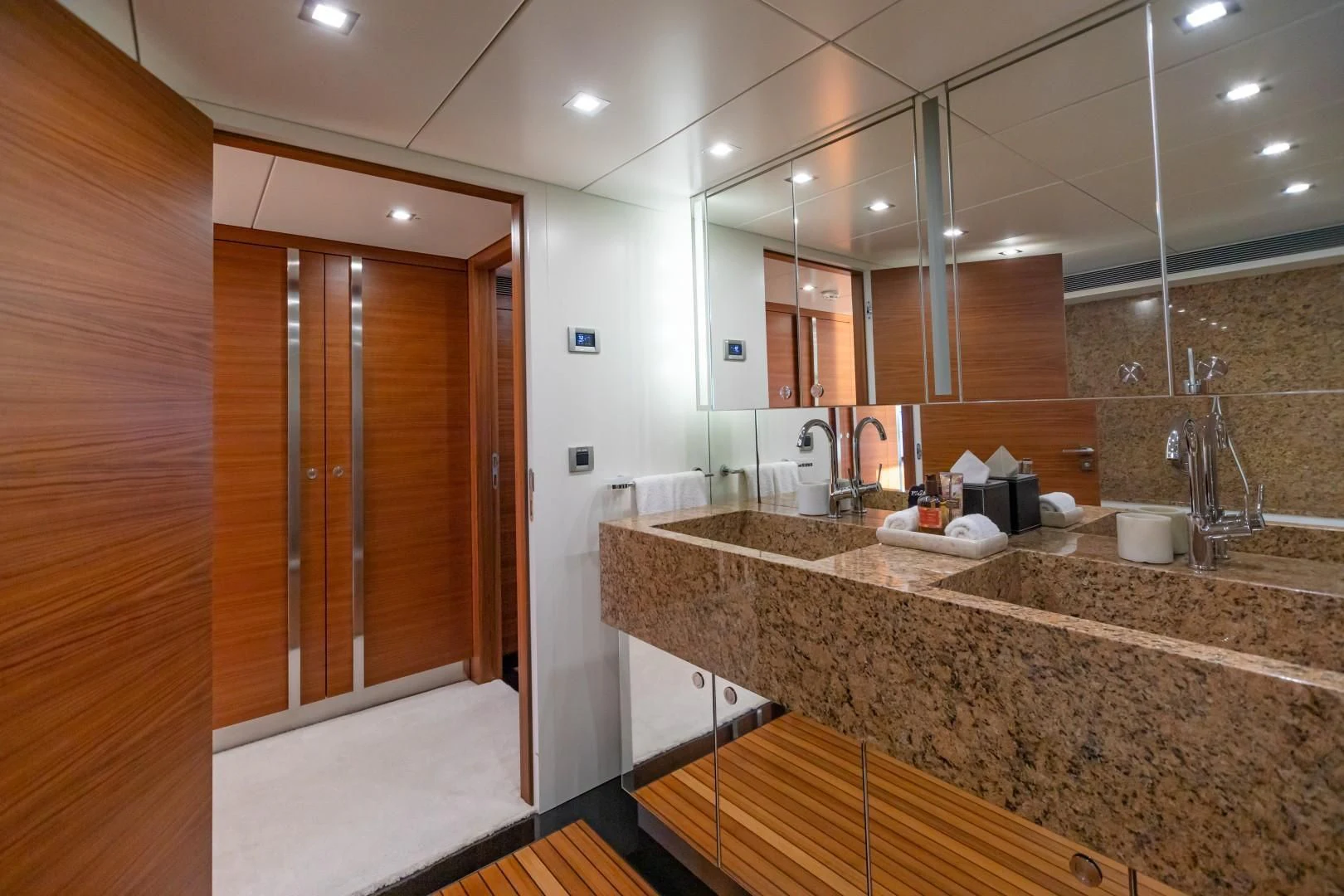 a bathroom with a countertop sink and a large mirror aboard SEA AXIS Yacht for Charter