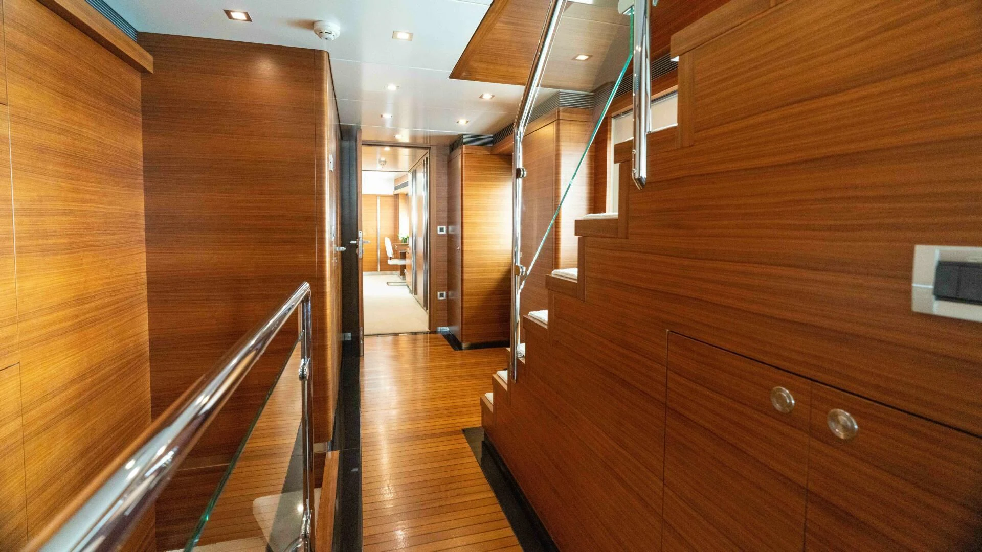 a room with wooden walls and a staircase aboard SEA AXIS Yacht for Charter