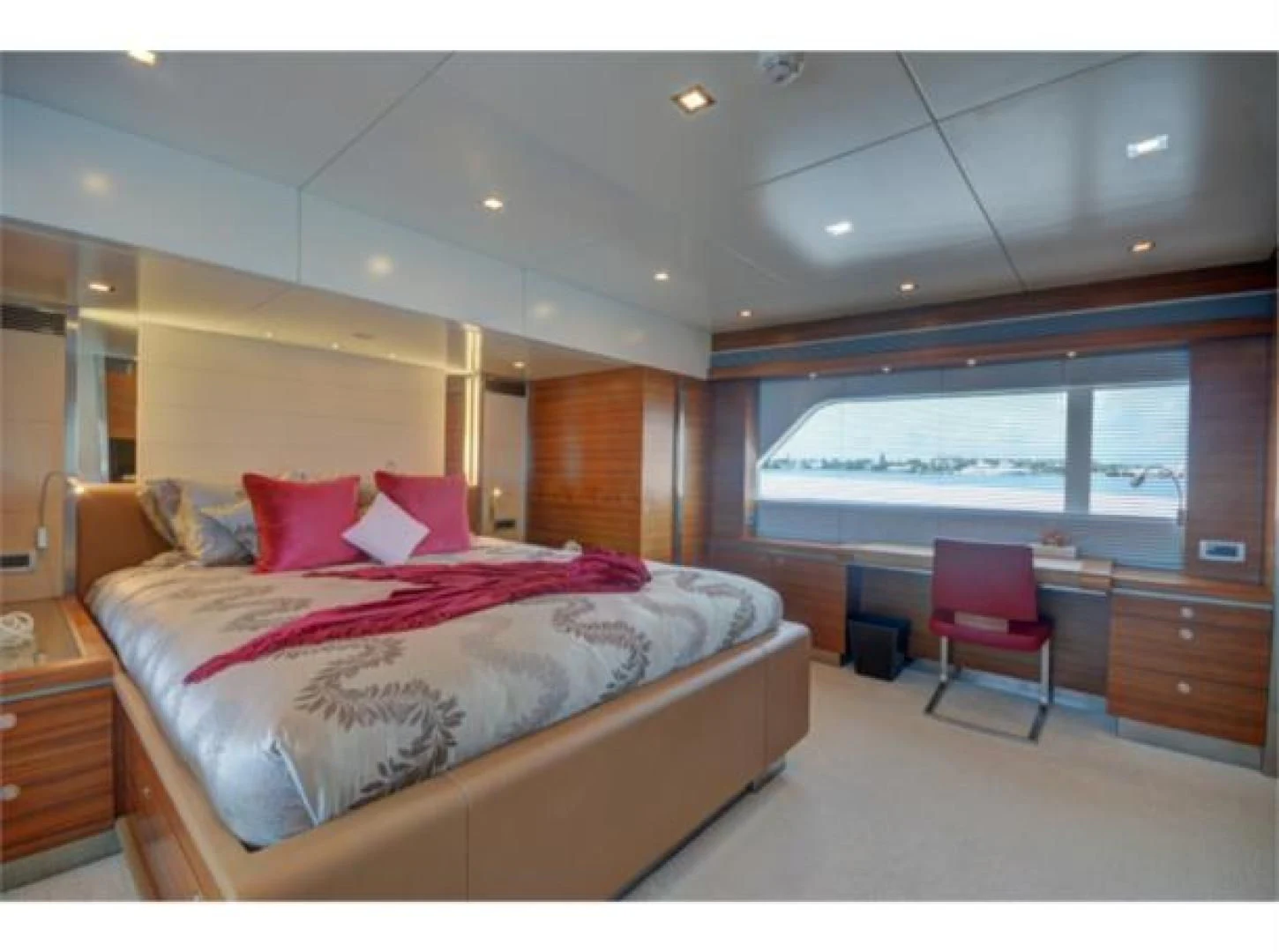 a bedroom with a bed and a chair aboard SEA AXIS Yacht for Charter