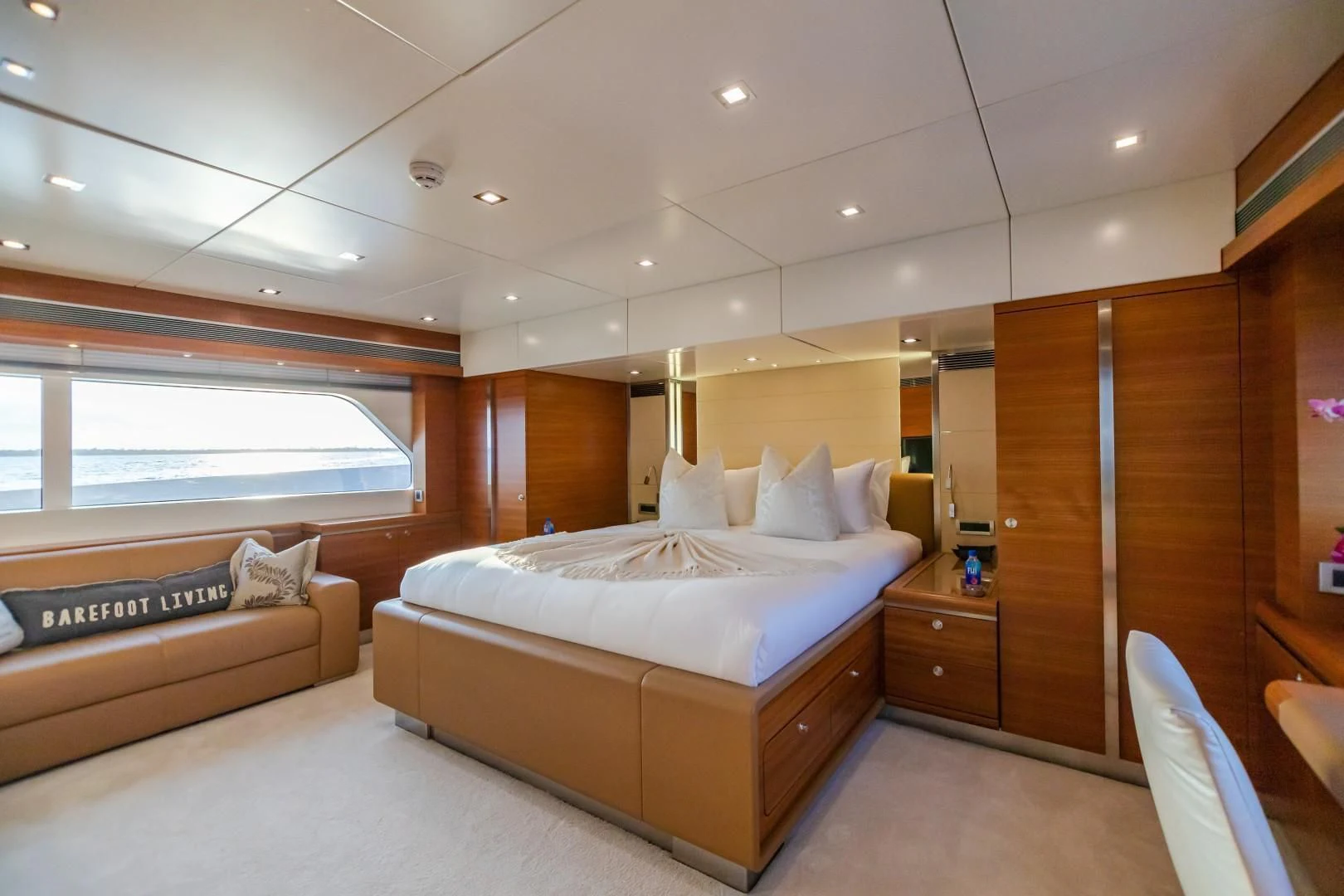 a room with a bed and a couch aboard SEA AXIS Yacht for Charter