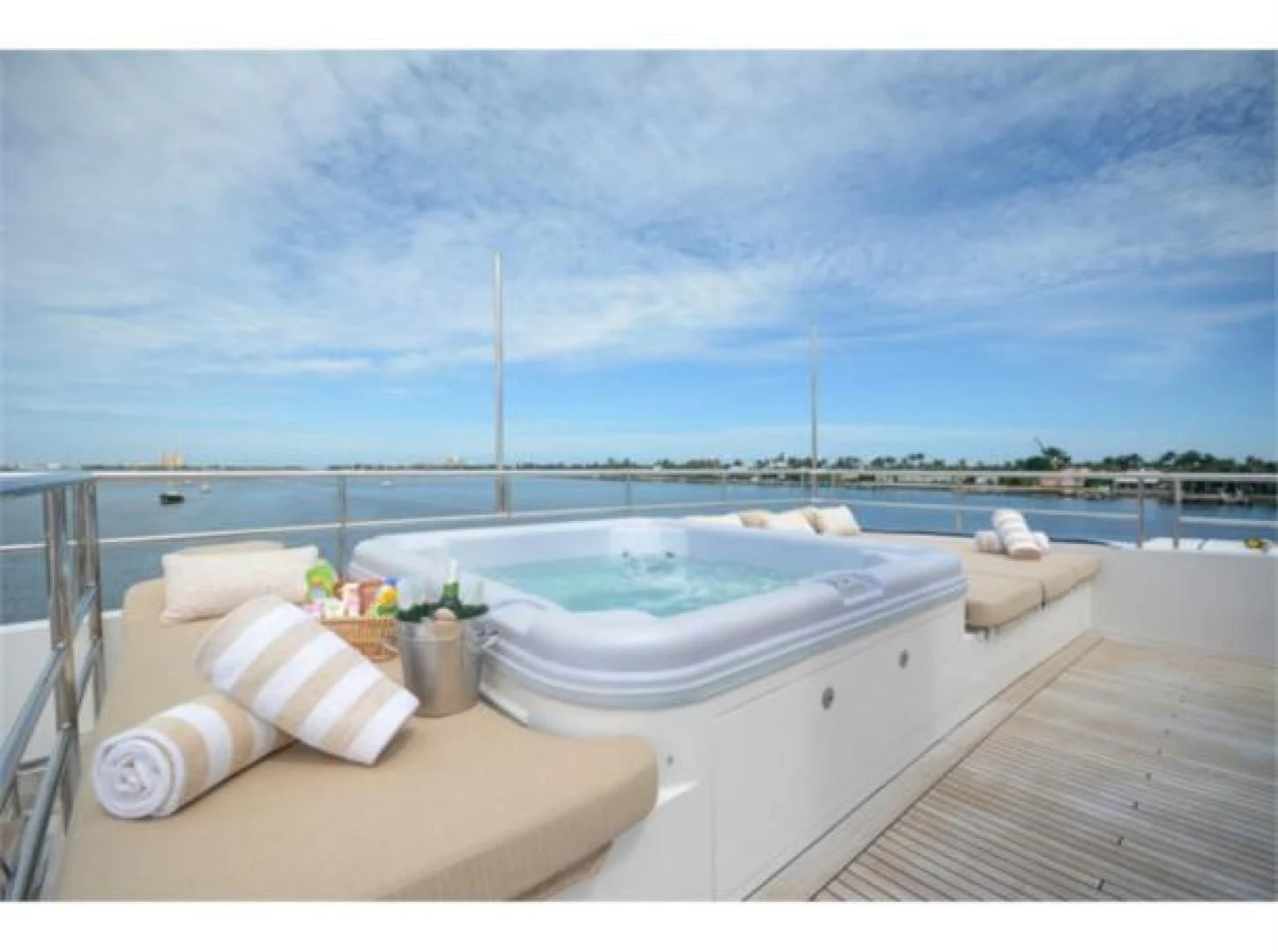 a large white bathtub with a white bed and a white pillow on a wooden deck with a aboard SEA AXIS Yacht for Charter