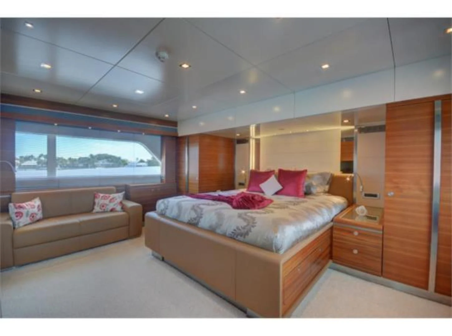 a bedroom with a bed and a couch aboard SEA AXIS Yacht for Charter