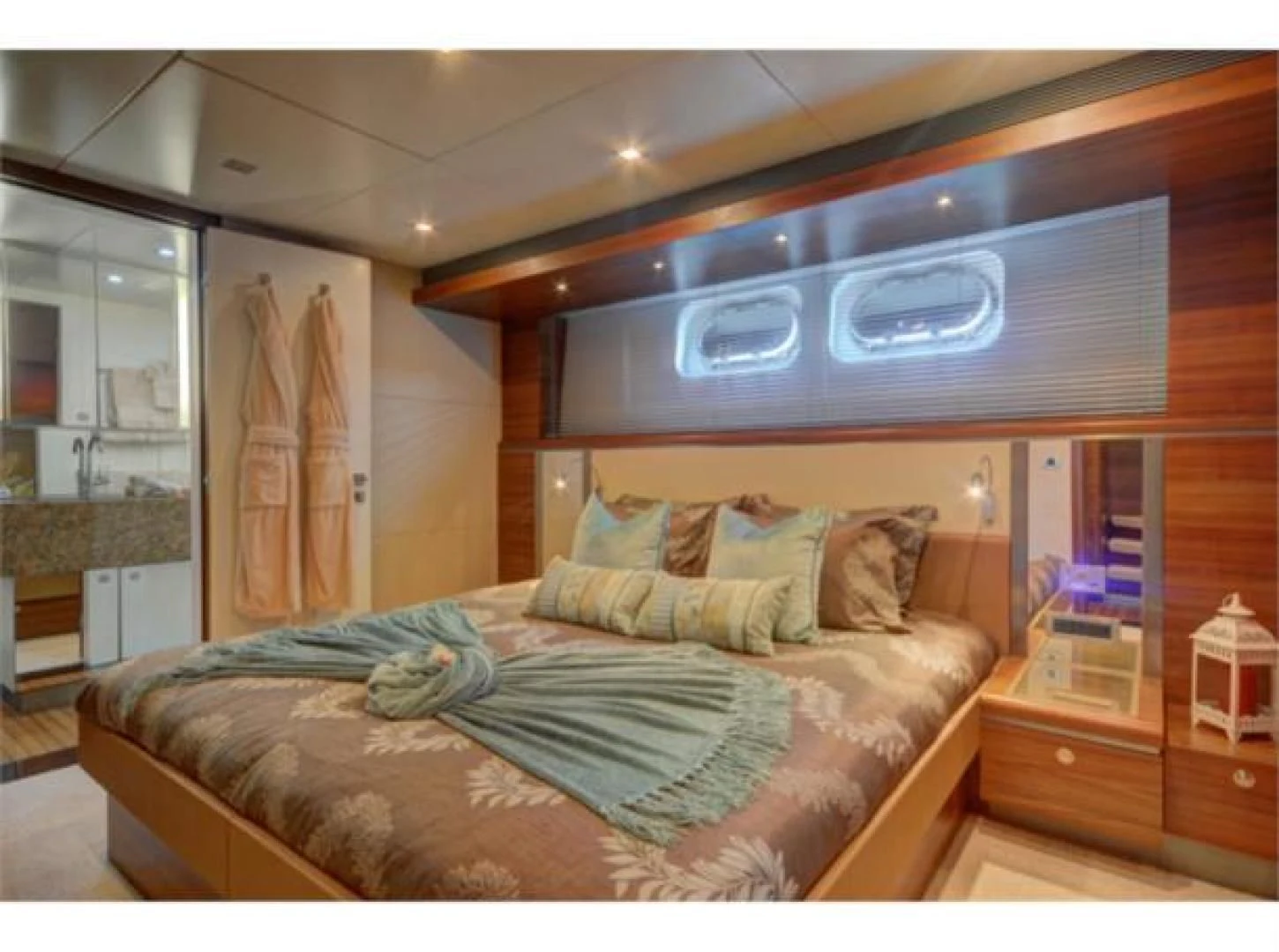 a bedroom with a bed and a television aboard SEA AXIS Yacht for Charter