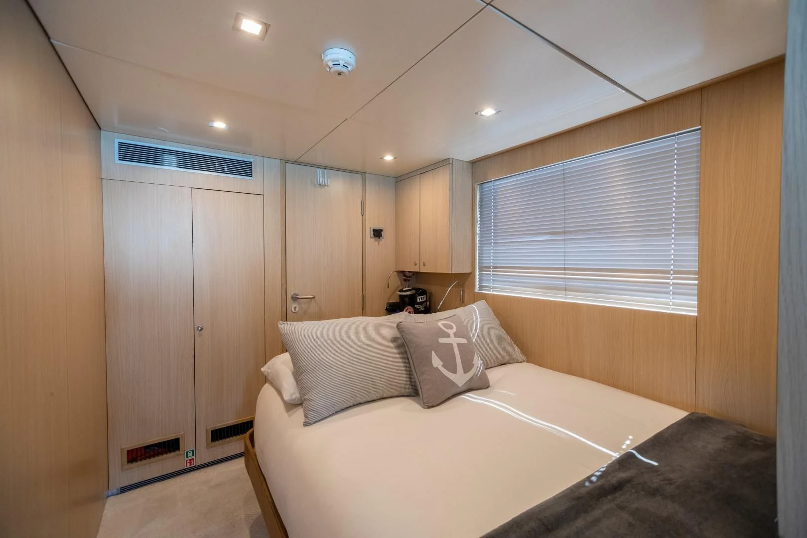 a bedroom with a bed and a closet aboard SEA AXIS Yacht for Charter