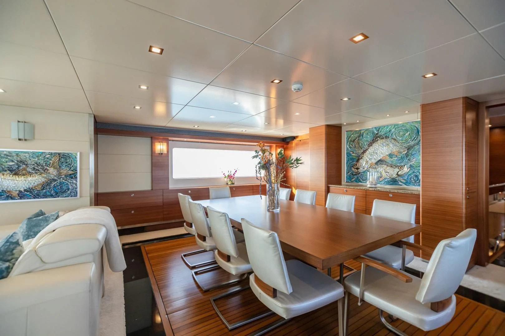 a room with a table chairs and a couch aboard SEA AXIS Yacht for Charter