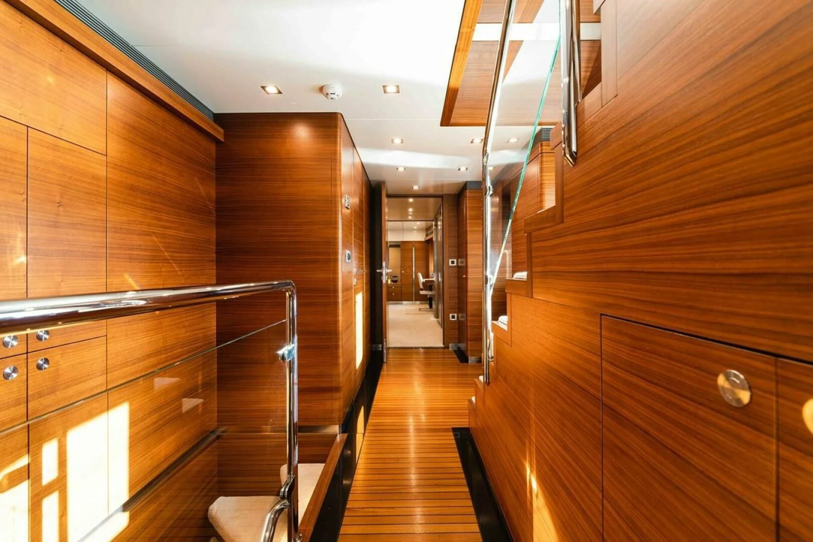 a wooden hallway with wooden cabinets aboard SEA AXIS Yacht for Charter
