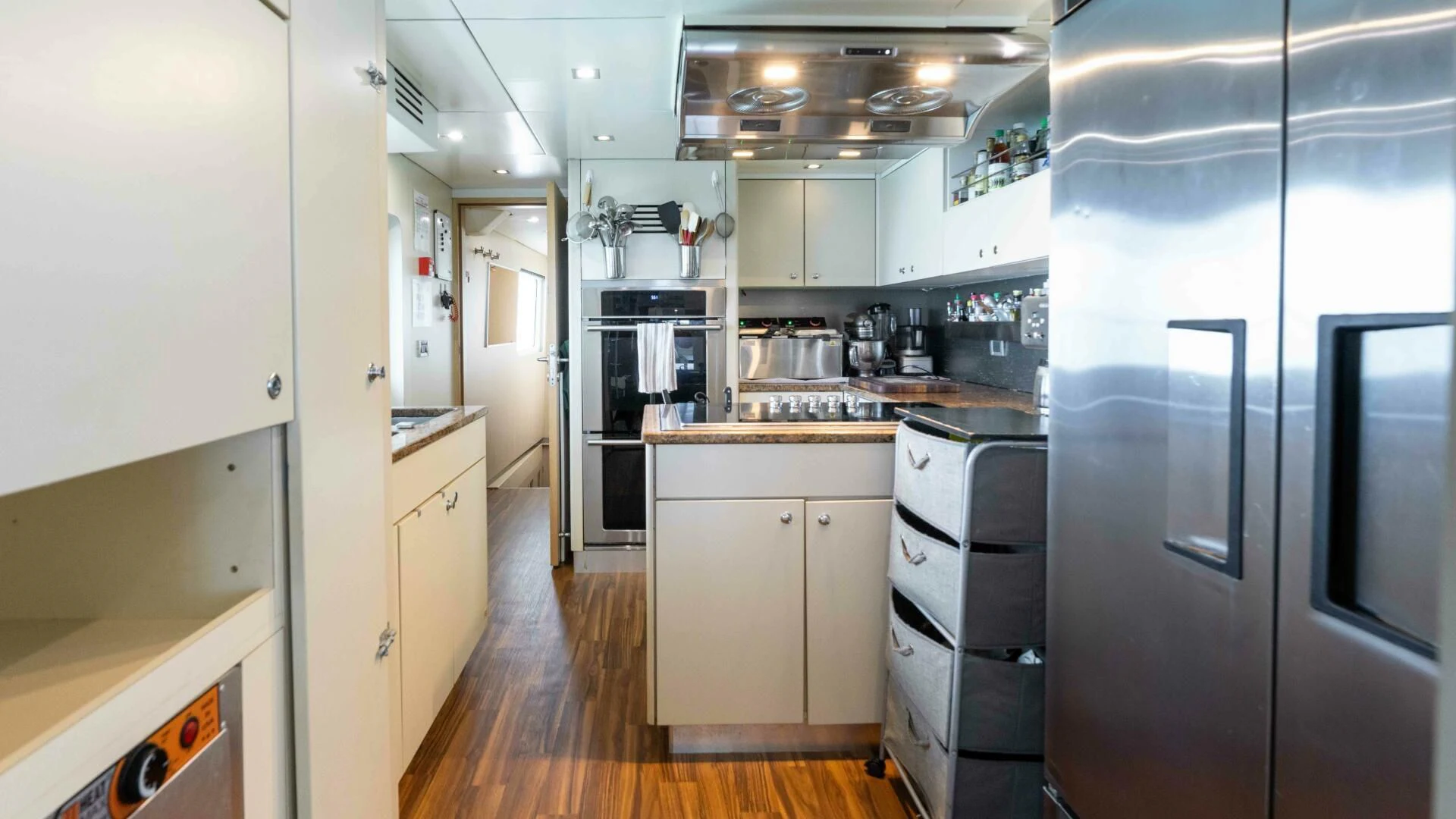 a kitchen with white cabinets aboard SEA AXIS Yacht for Charter