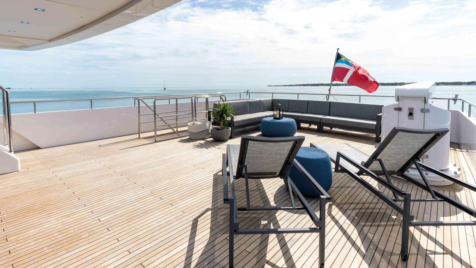 a deck with chairs and a flag aboard SEA AXIS Yacht for Charter