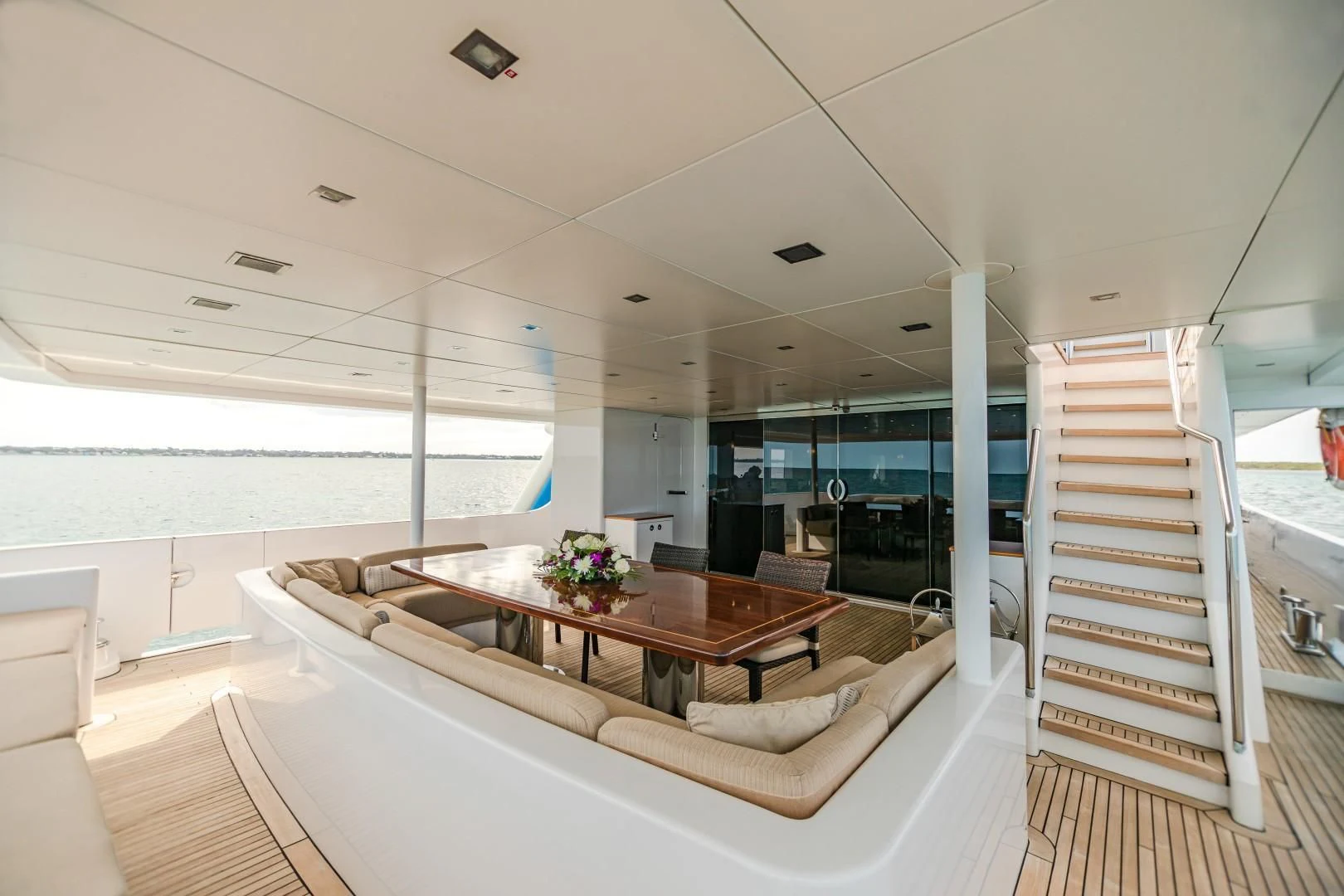 a modern bedroom with a large window aboard SEA AXIS Yacht for Charter
