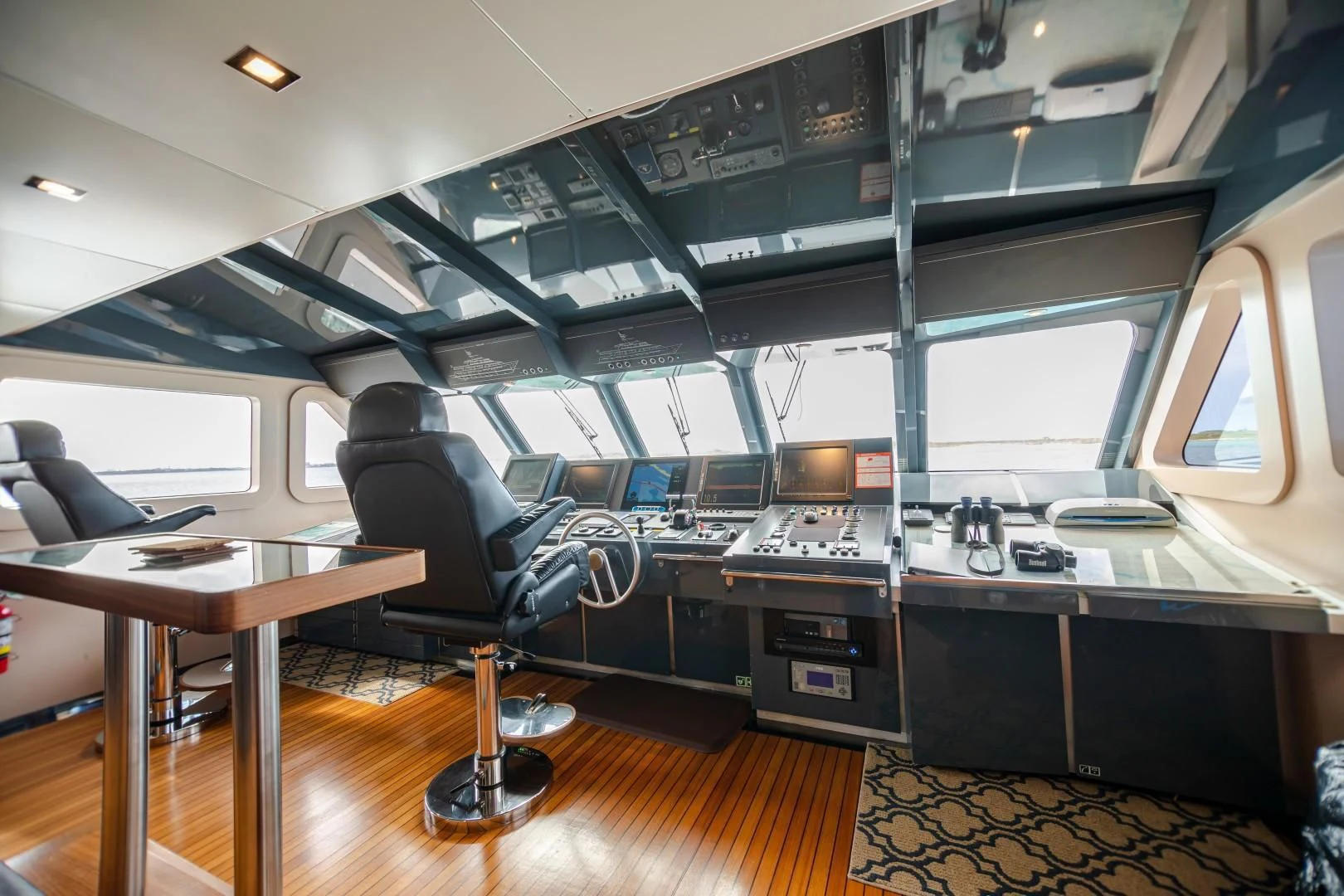a person sitting in a chair in a control room aboard SEA AXIS Yacht for Charter