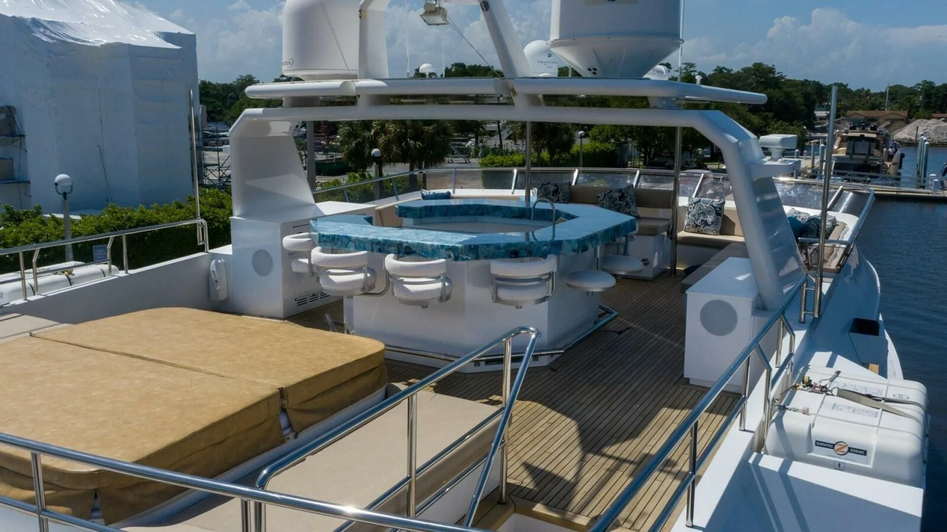 a deck with a pool and a deck with chairs and a building aboard SEA AXIS Yacht for Charter