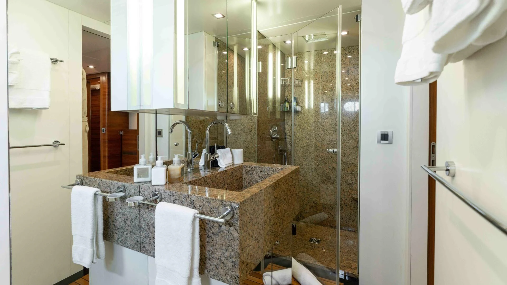 a bathroom with a sink and a shower aboard SEA AXIS Yacht for Charter